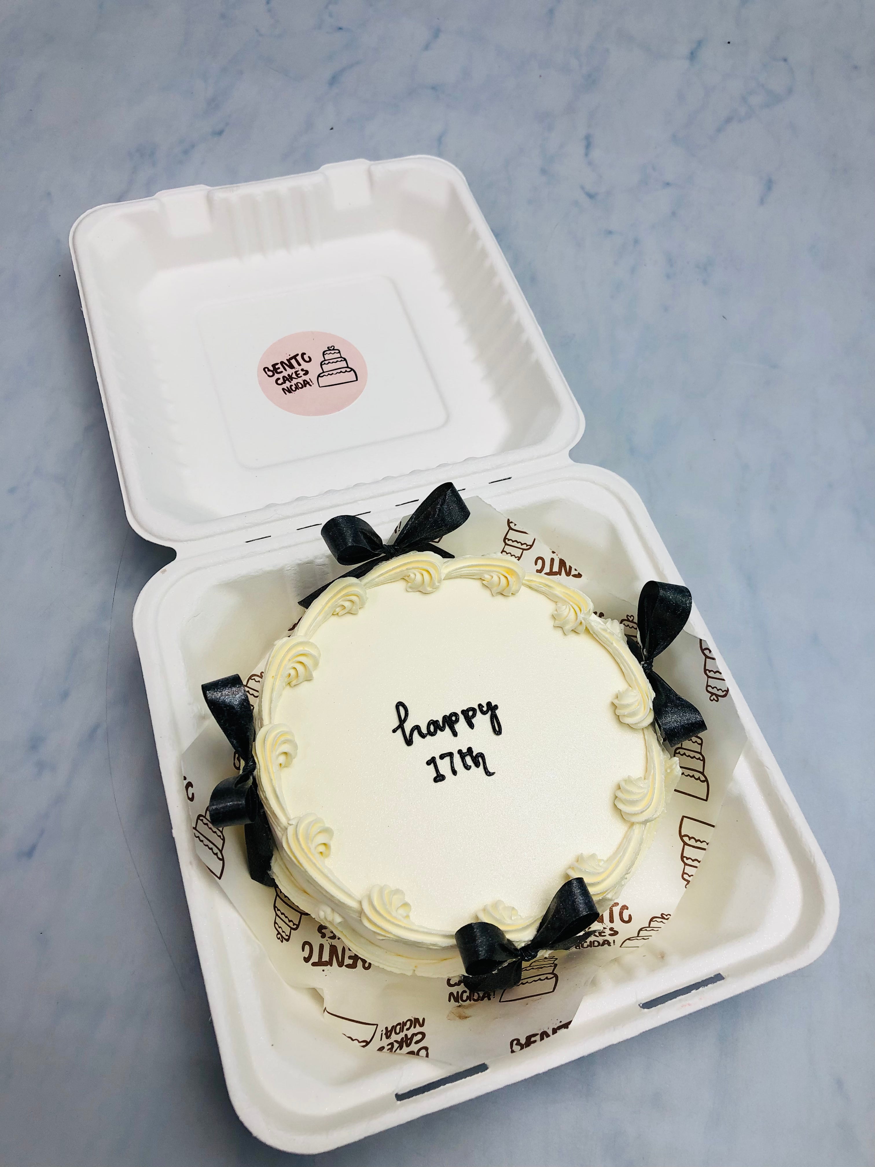 Bow theme white bento cake is designed for 17th birthday celebration.