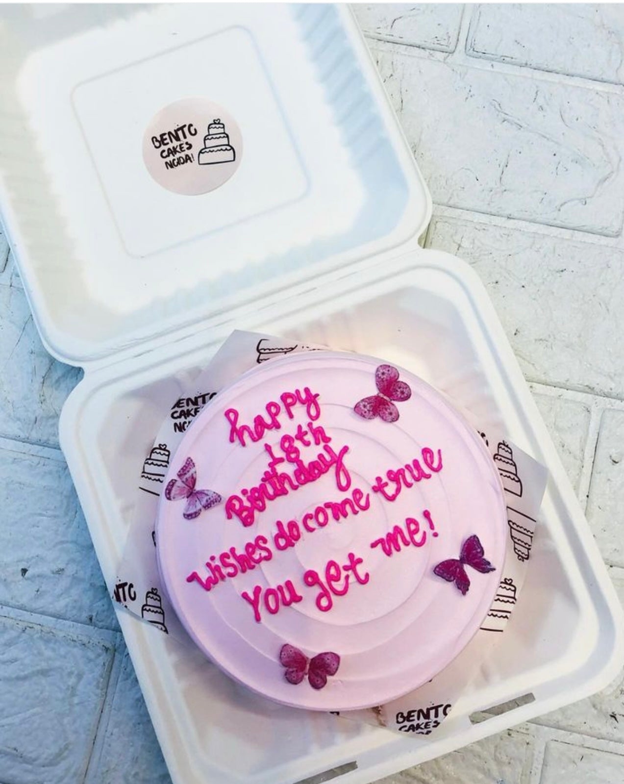 Birthday theme pink color bento cake is decorated with Butterflies and its specially for birthday occasions.