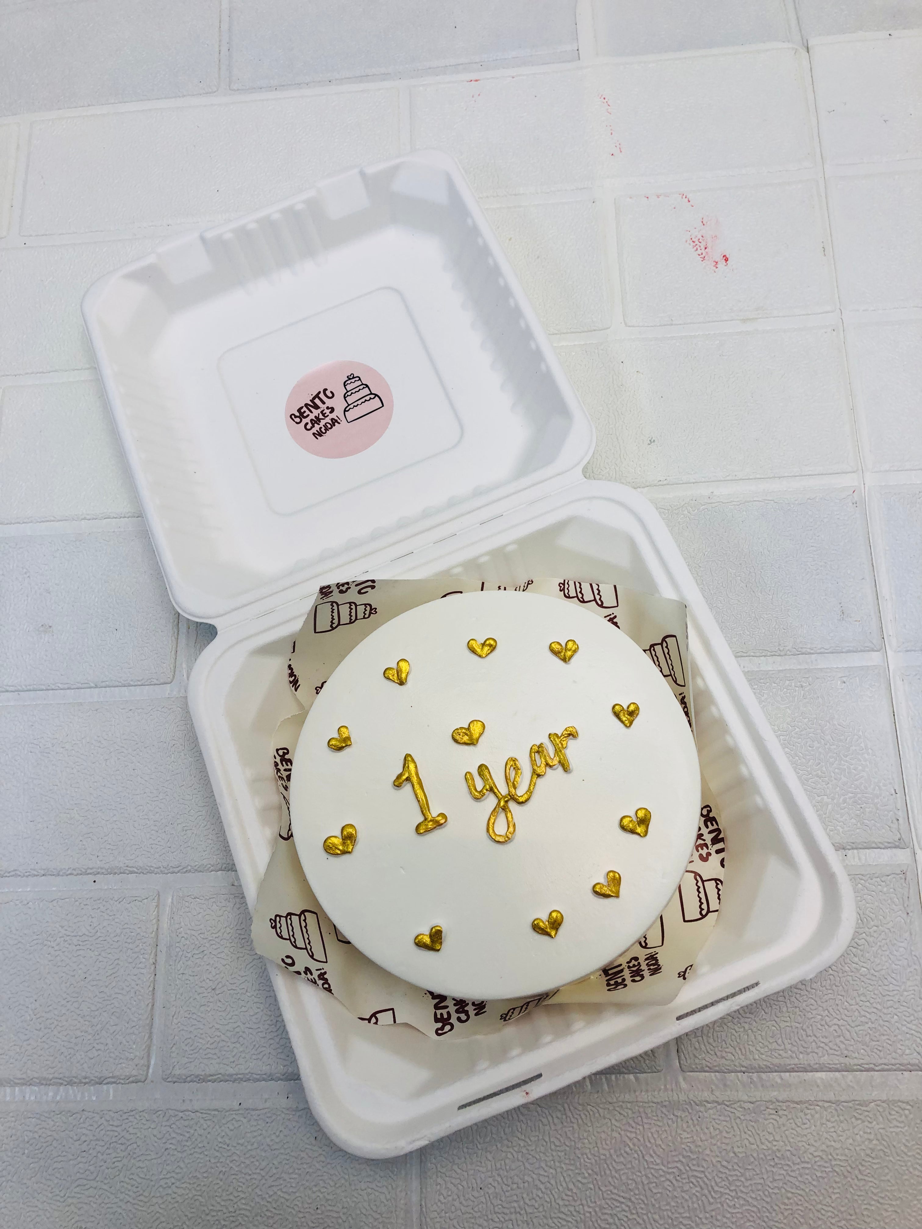 White bento cake is decorated with golden hearts design and is specially for Anniversary celebration.