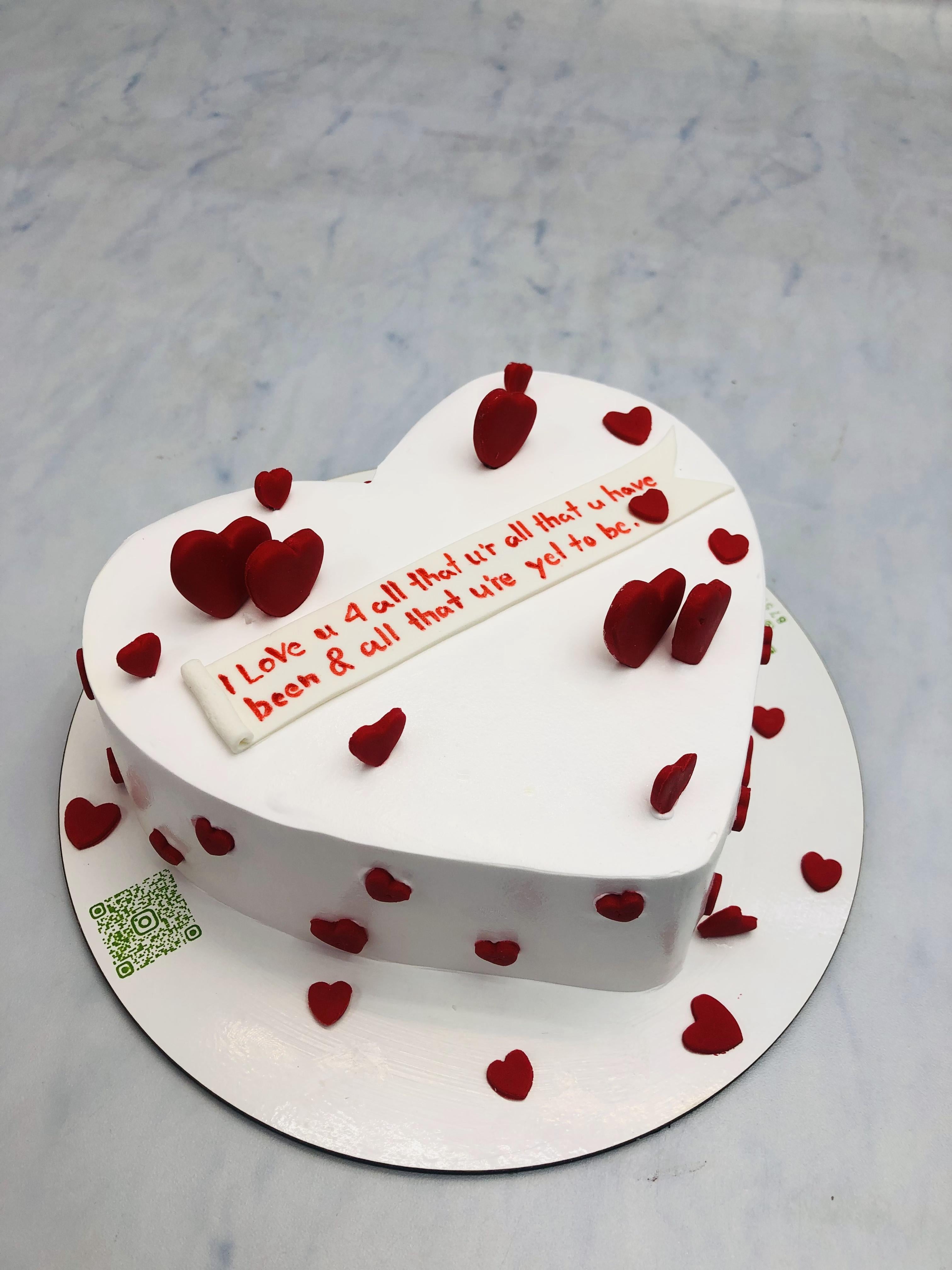 Red Hearts on White Heart Shape Cake
