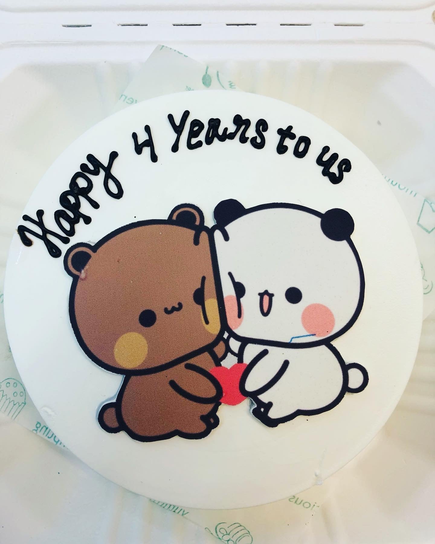 A white bento cake having a attached bubu dudu celebrating 4 years of anniversary.