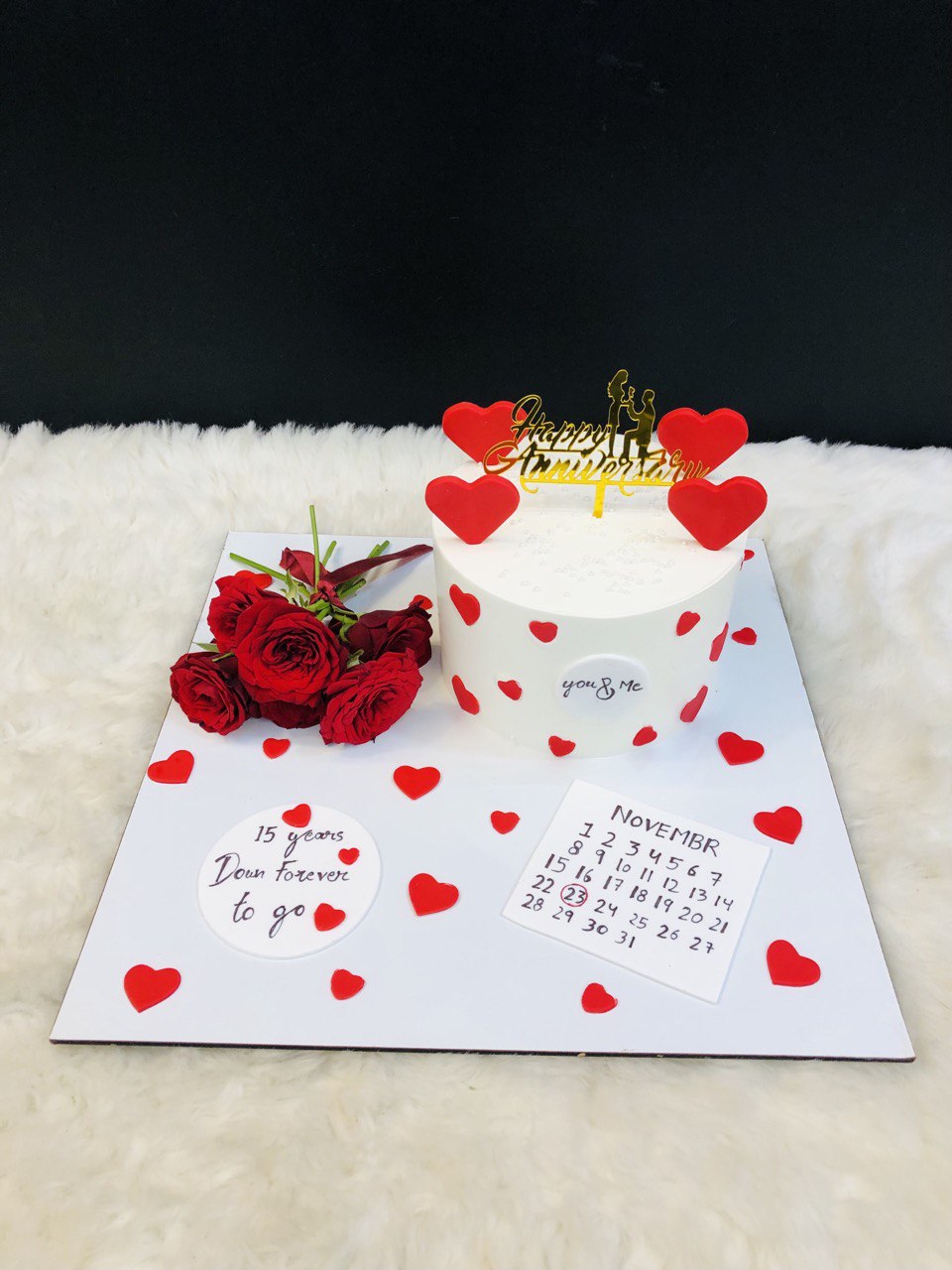 15th Anniversary Cake – White Frosting with Red Hearts & Gold Couple Topper