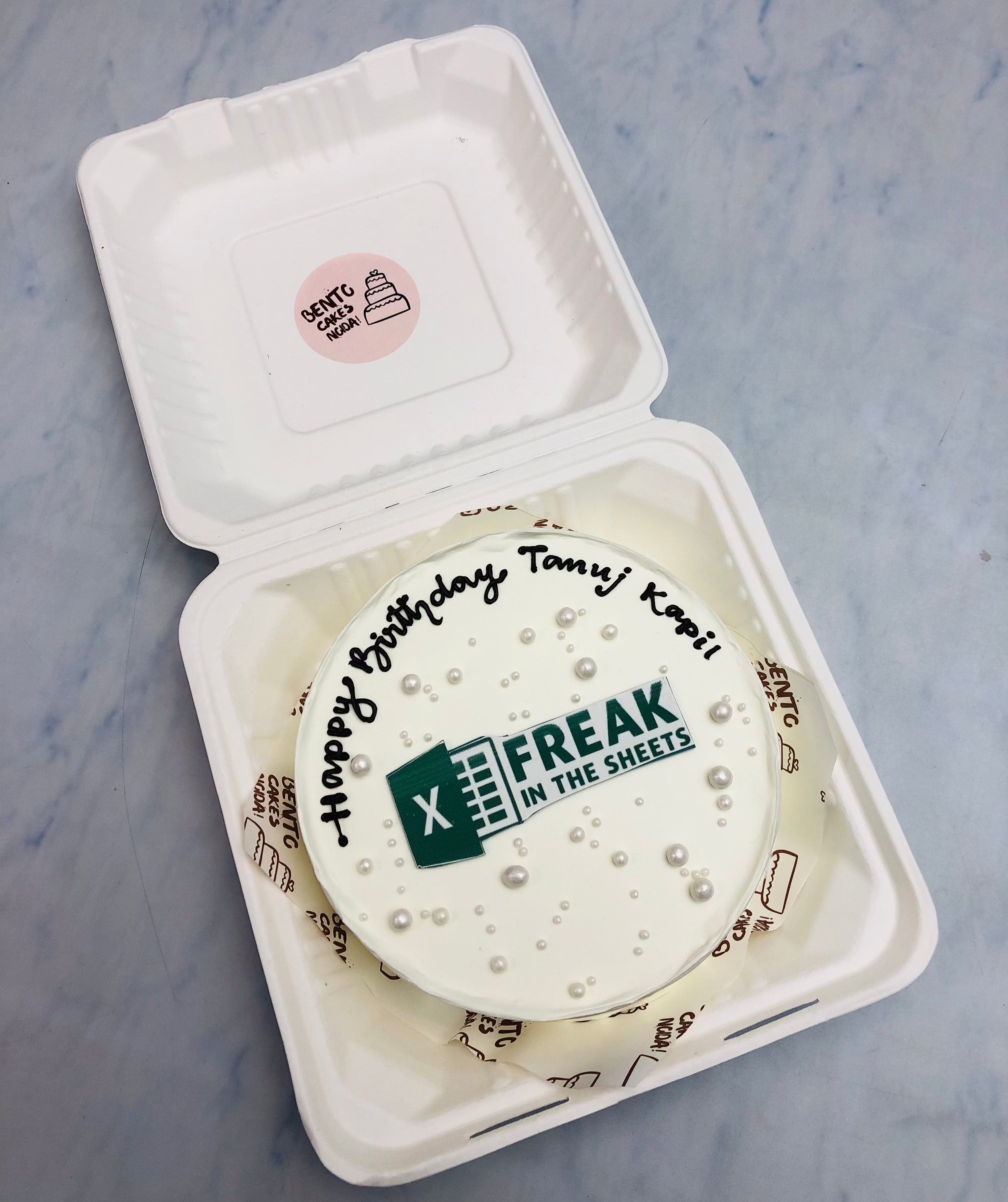 An elegant white bento cake with an excel software theme for account birthday.