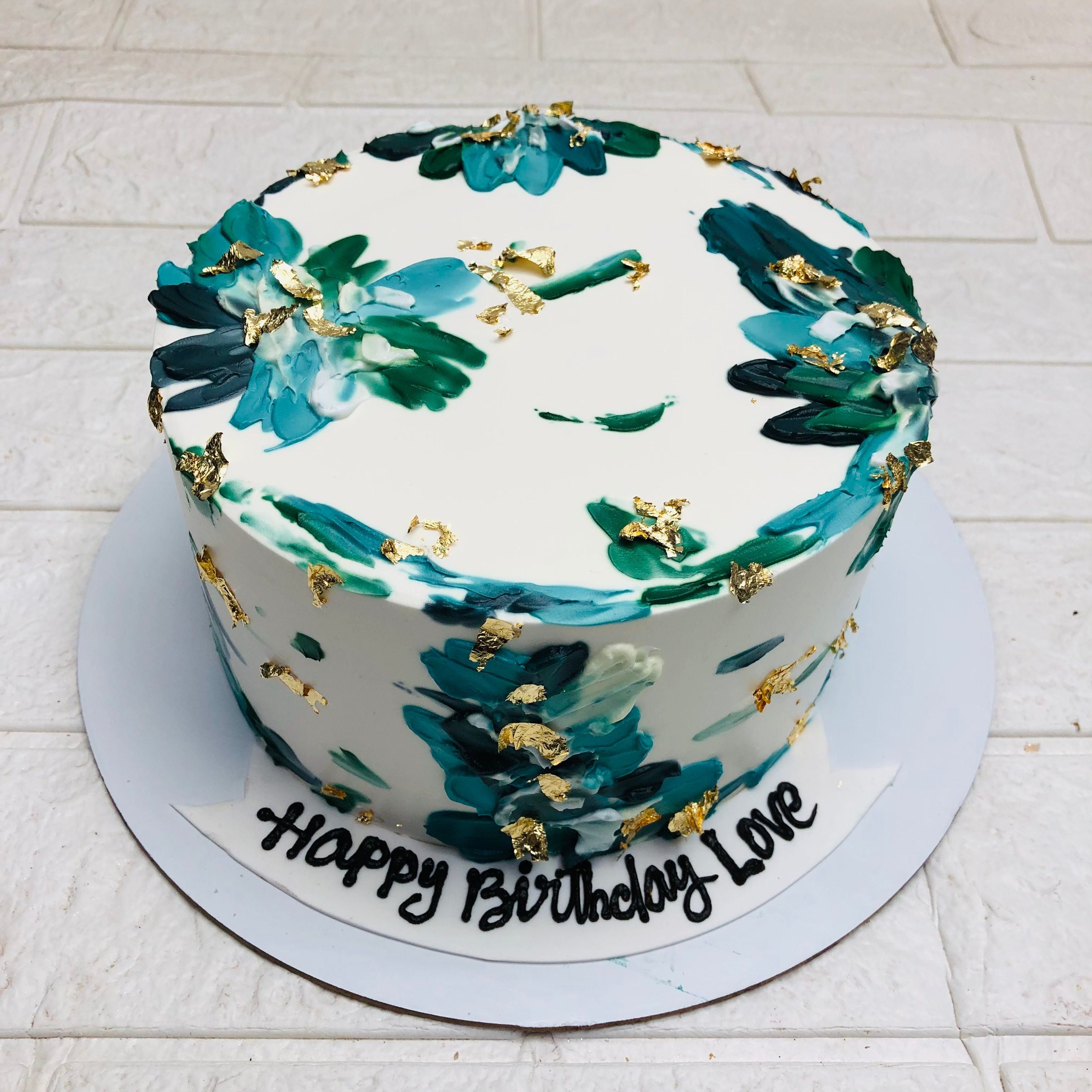 This green floral designed cake is decorated with golden works and can be used for multiple occasions.