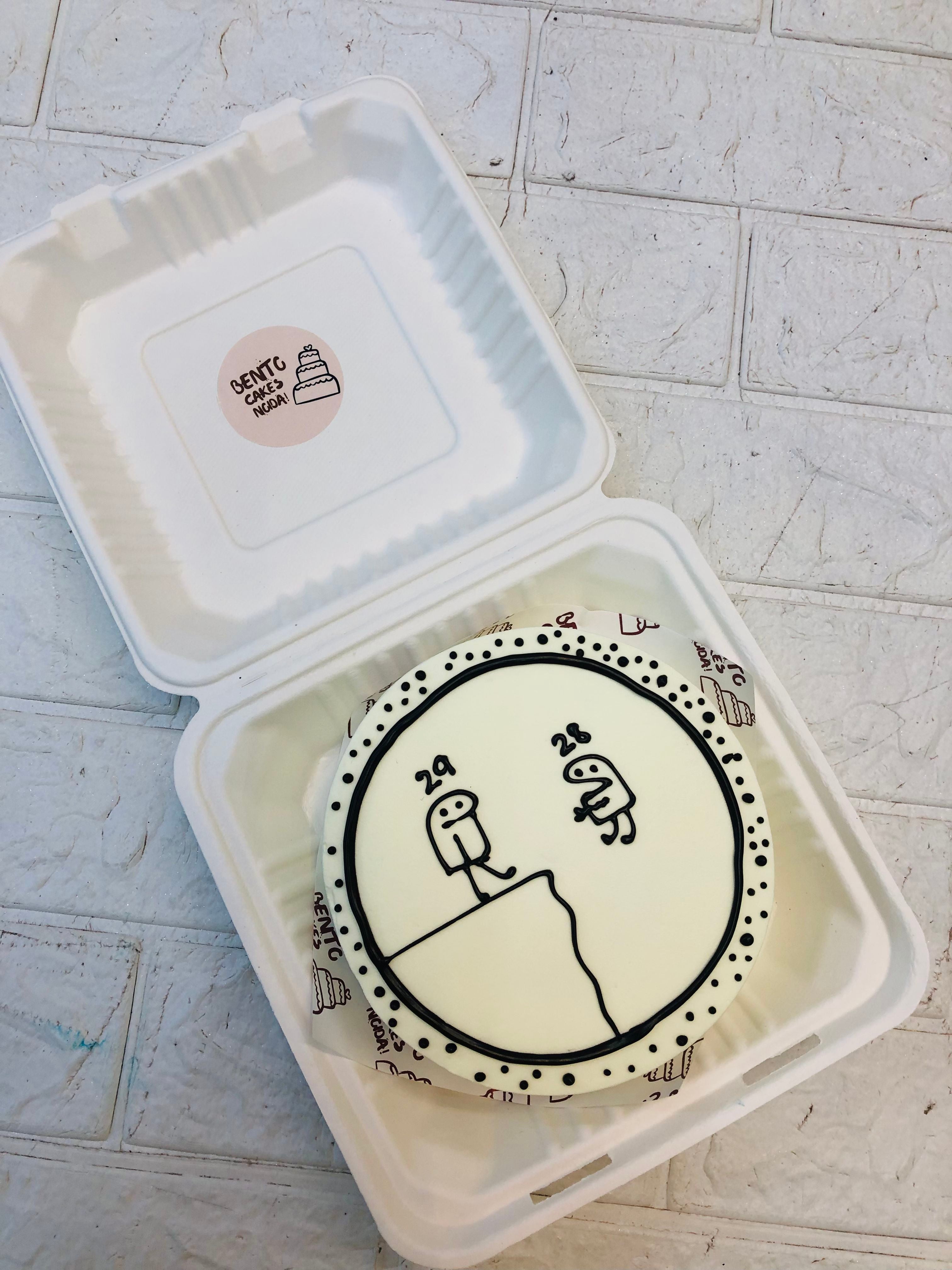 A white cake with two mimi cartoons design.