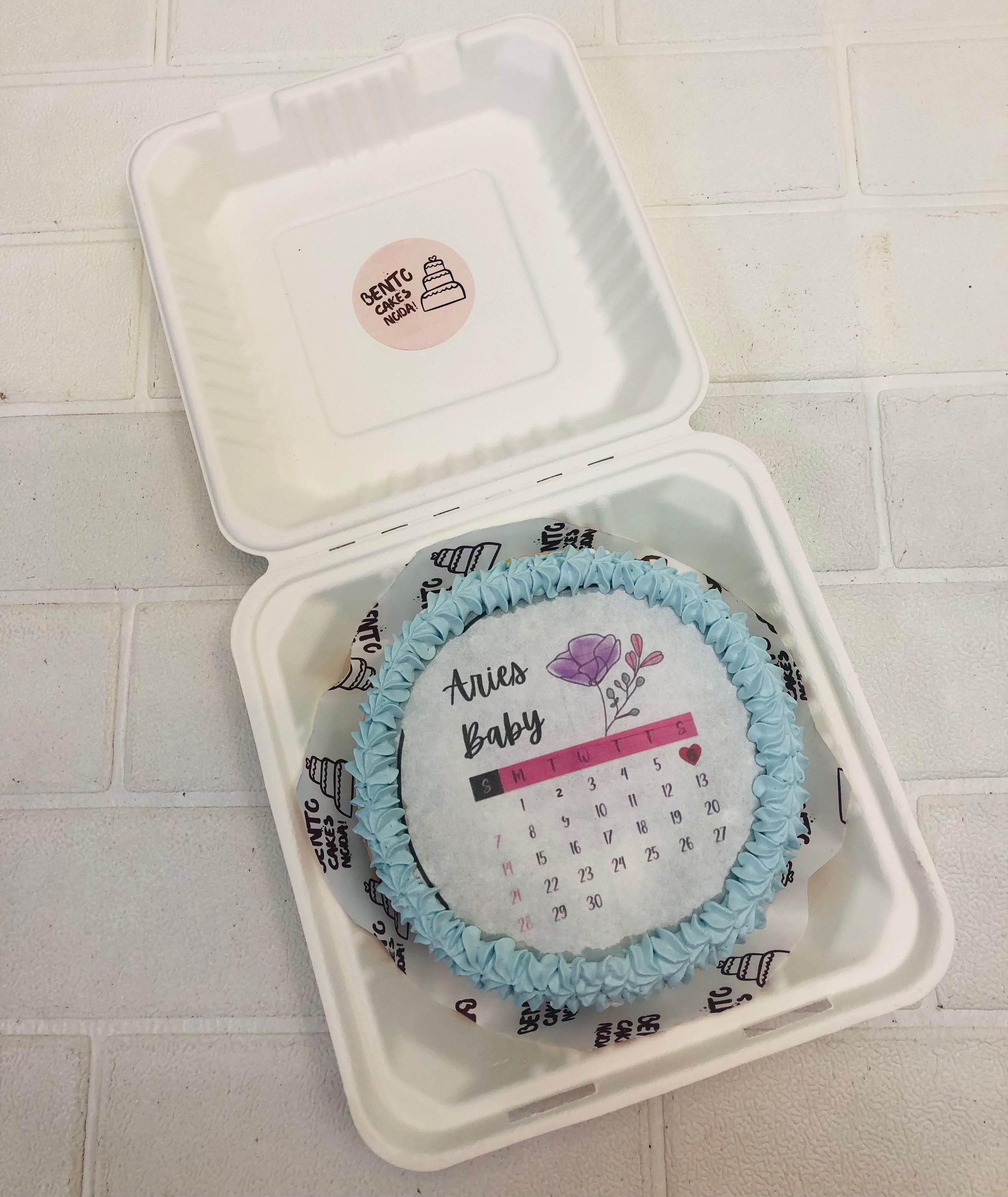 A Arise Baby theme fire bento cake with blue truffle on its boundary.