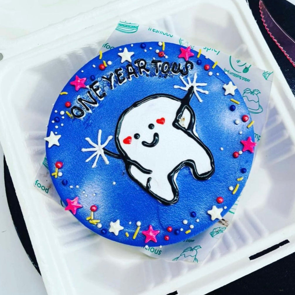 An image of a tooth contained within a box that exhibits a blue and white design, emphasizing creativity and charm.