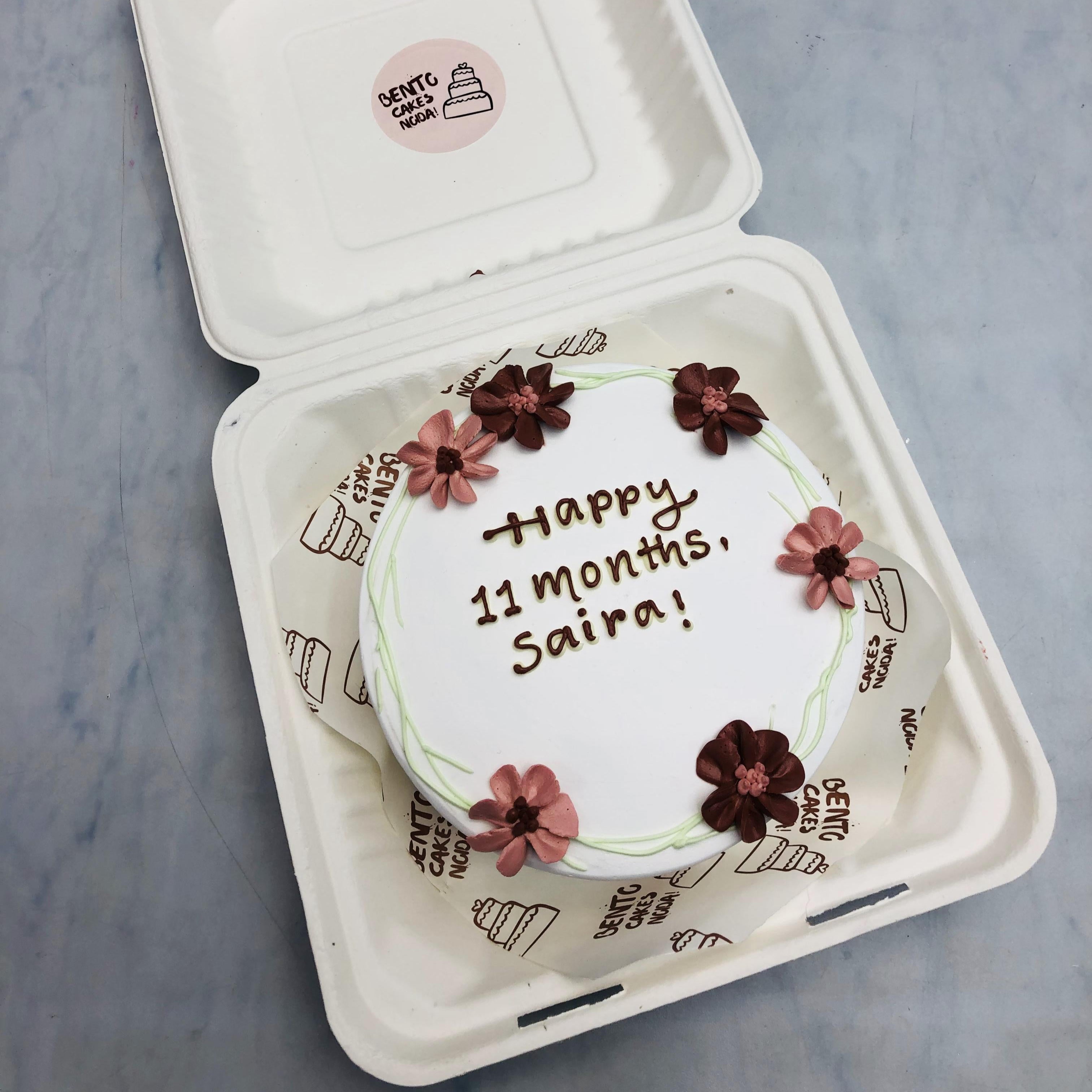 An aesthetic floral design white bento cake for 11 months baby girl.