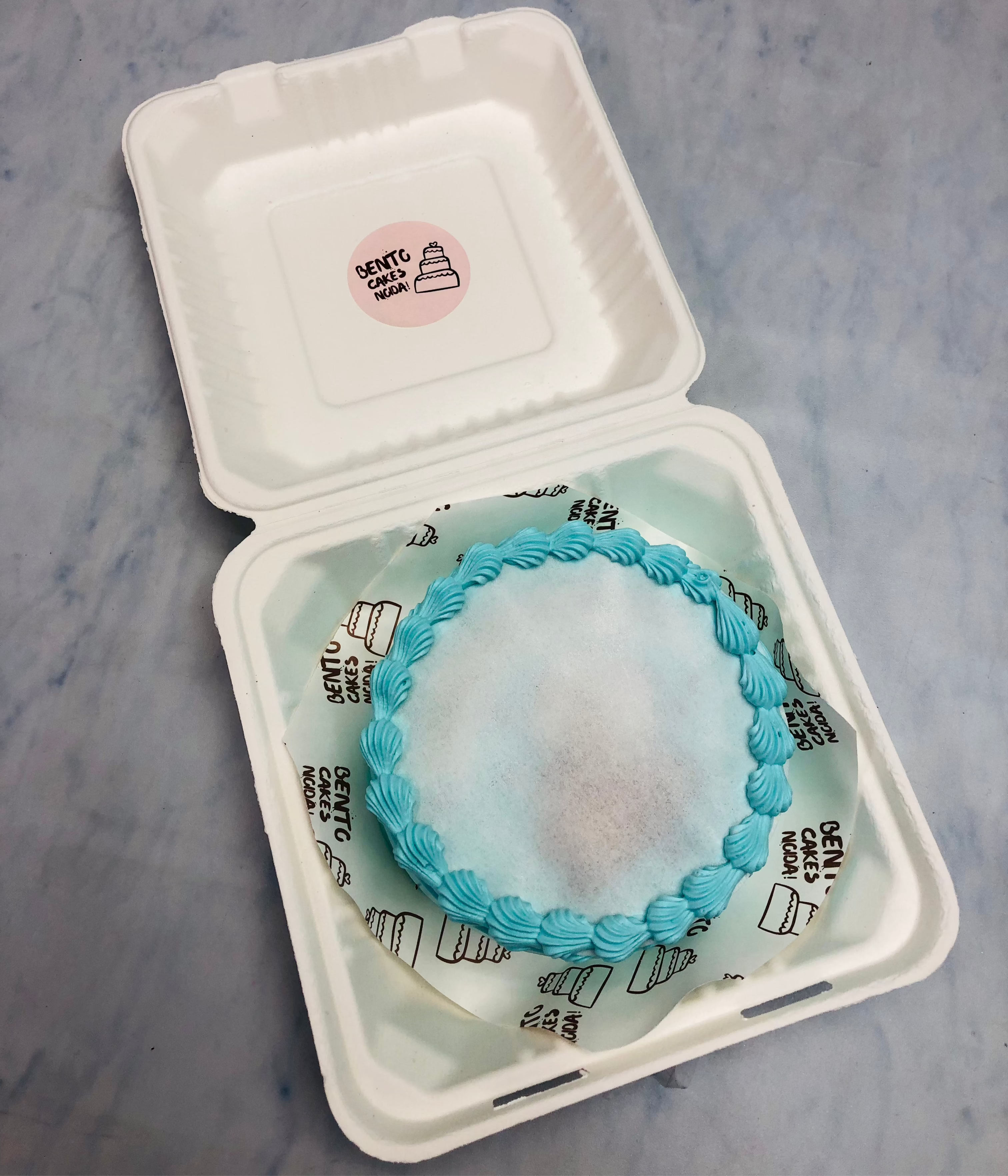 A light blue truffle design fire bento cake.