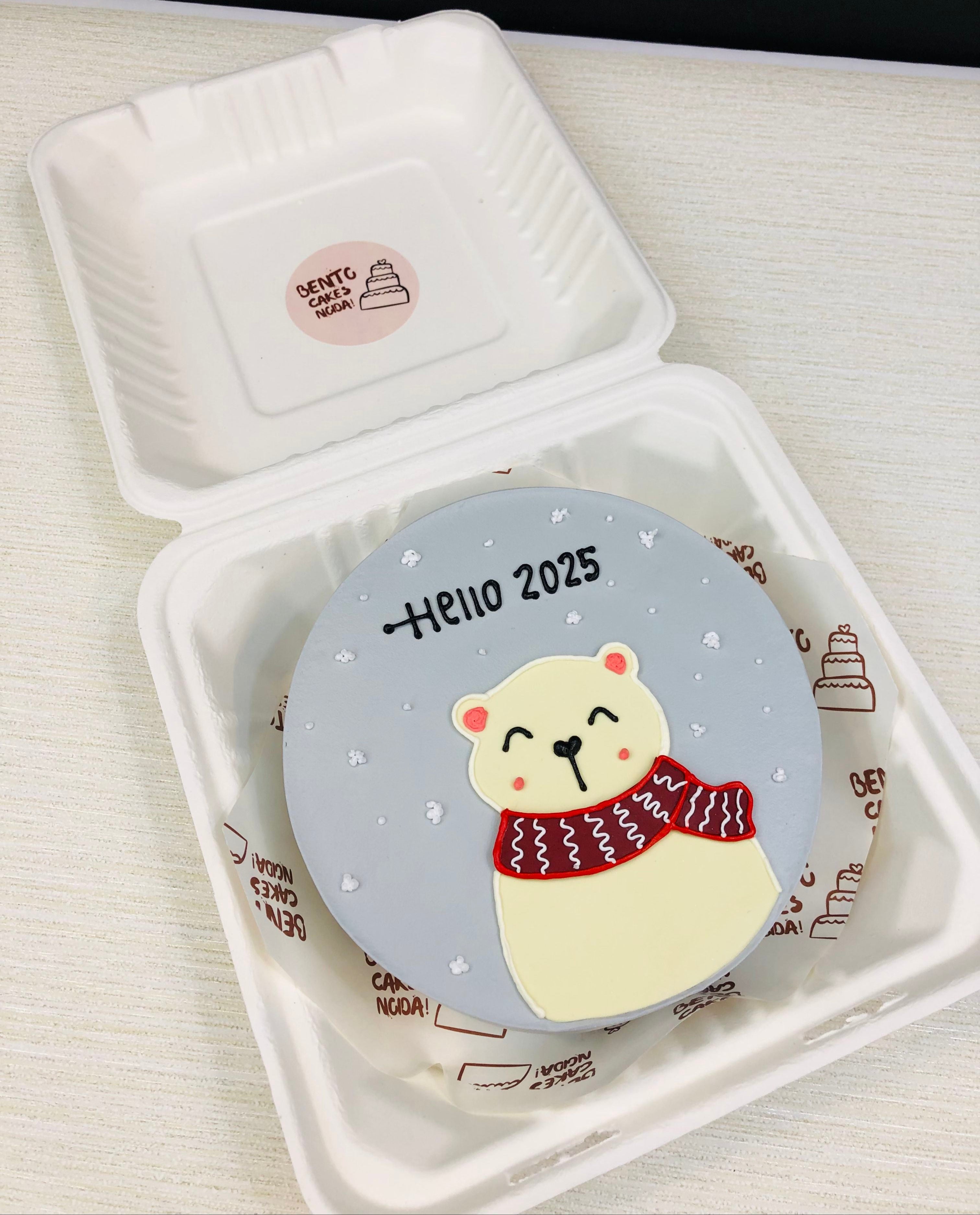 A grey bento cake having a polar bear welcoming New Year.