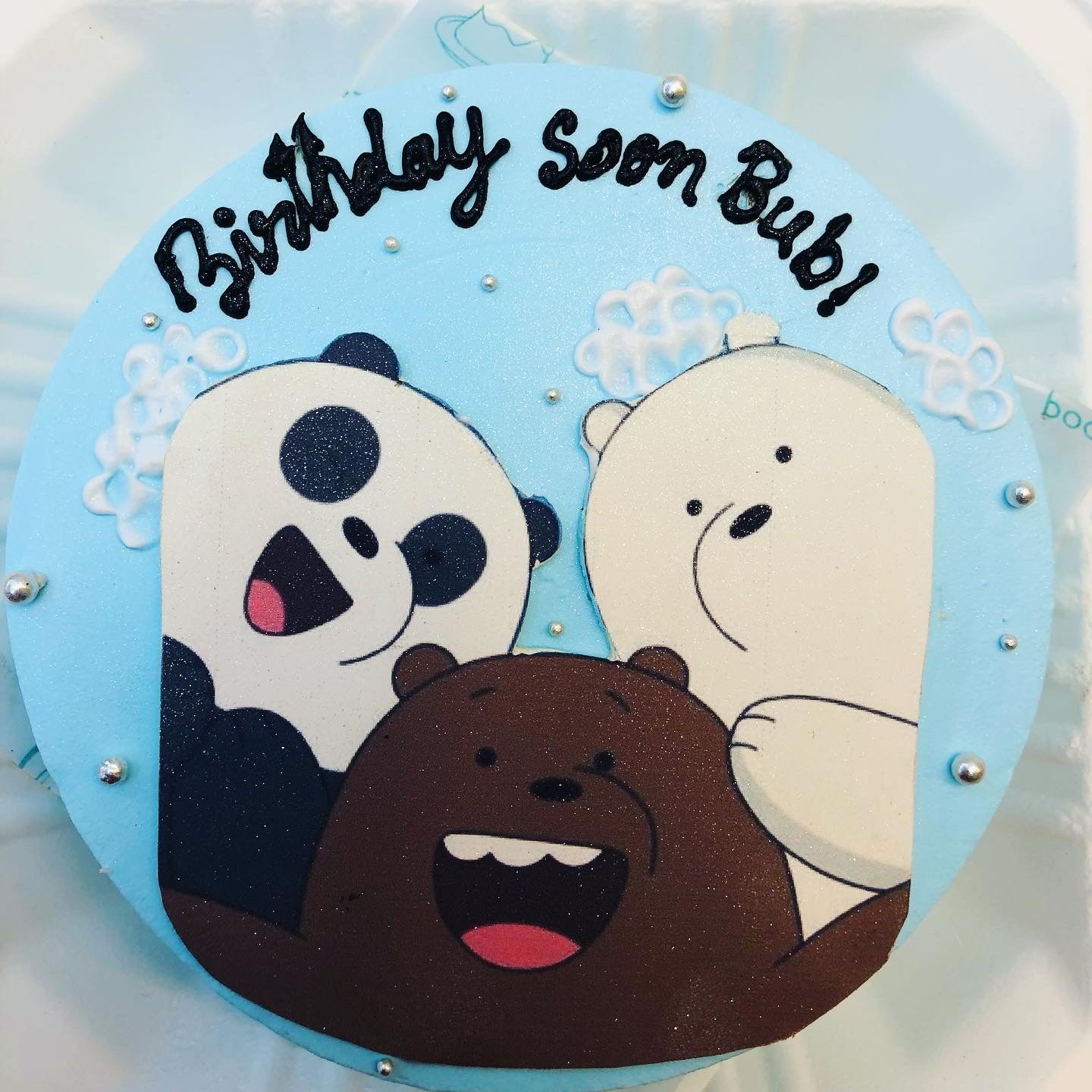 A delightful birthday cake adorned with a bear and panda, perfect for a festive celebration.