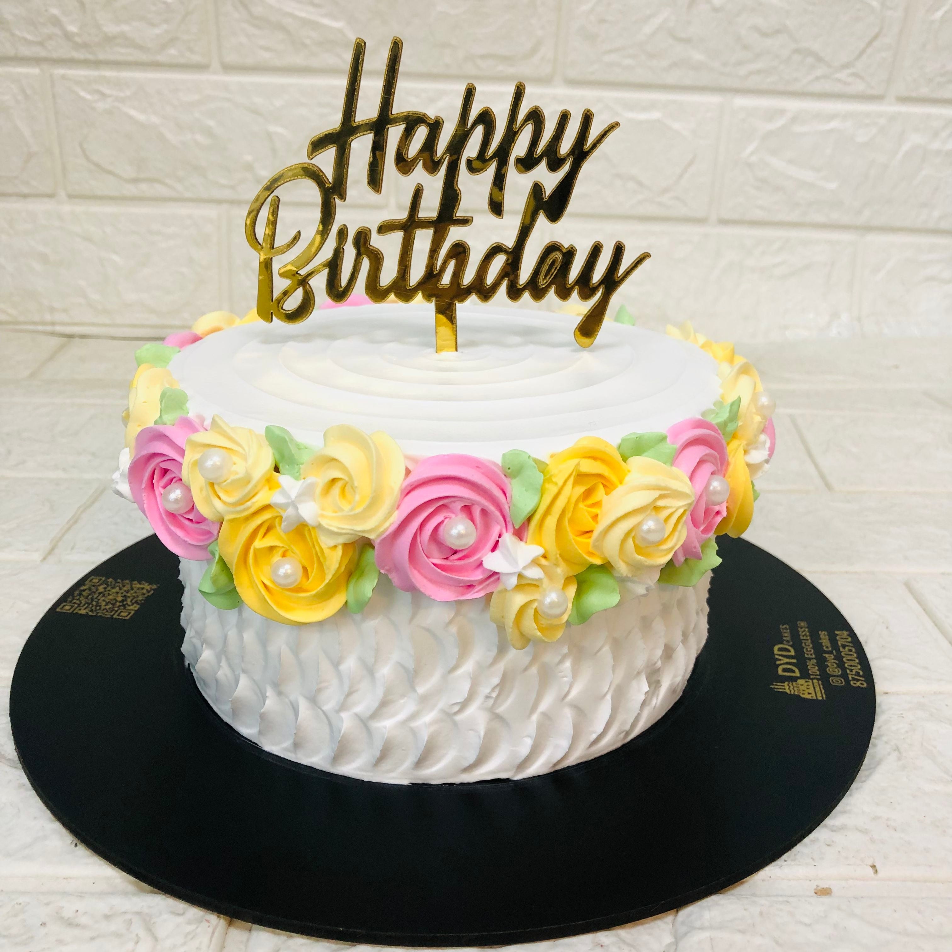 A beautifully decorated birthday cake featuring a vibrant "Happy Birthday" sign, perfect for a joyful celebration.