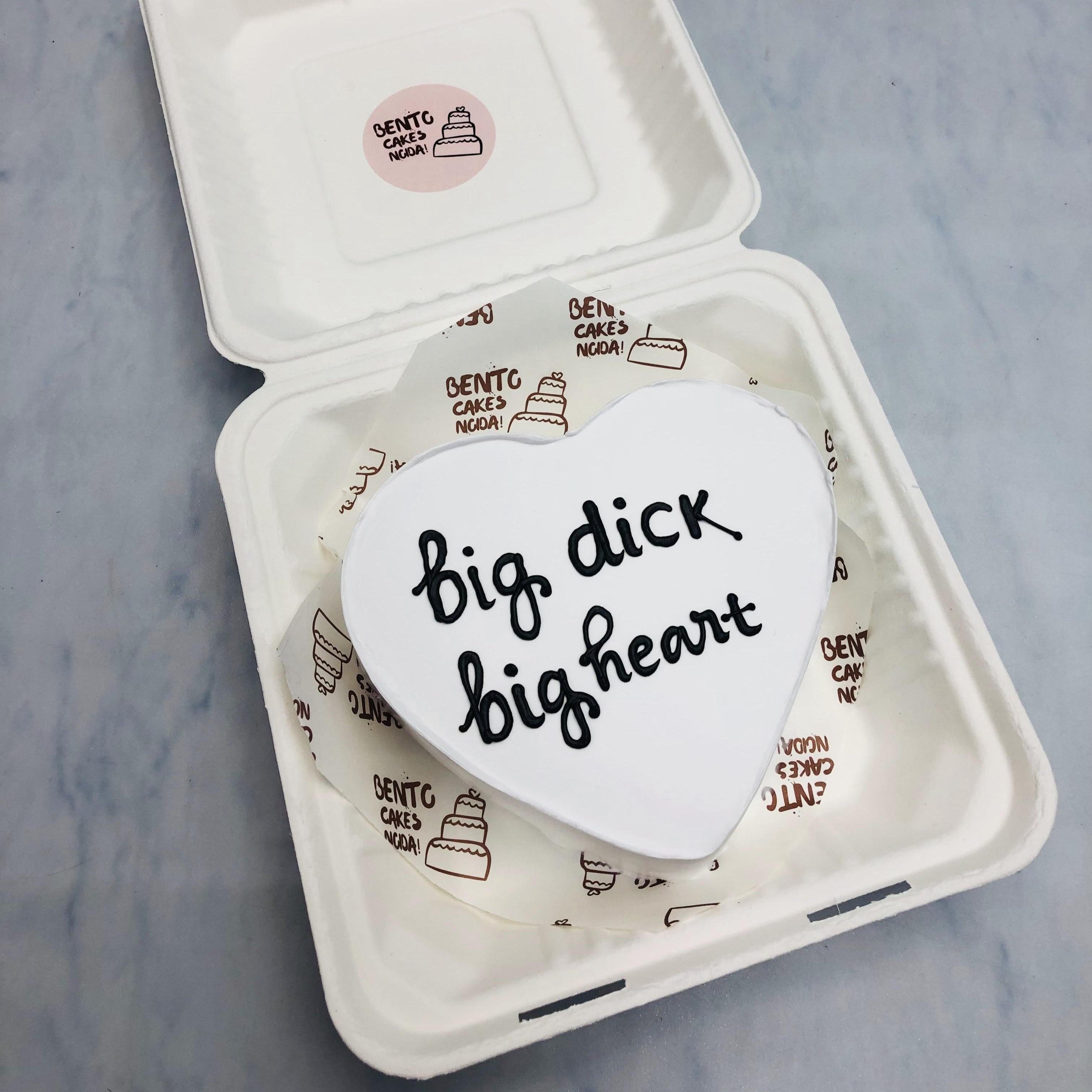A white heart shape bento cake with a bachelor text written on it.