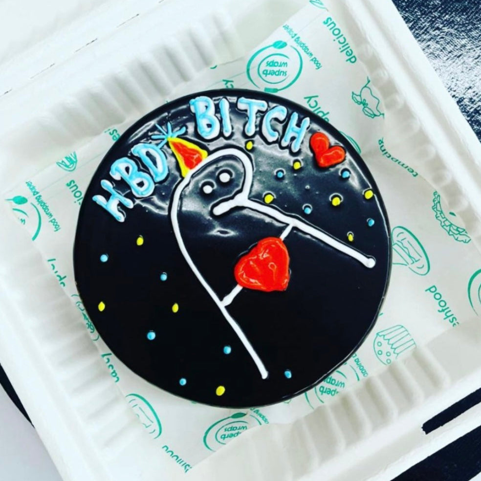 A striking black and white cake adorned with a whimsical unicorn, perfect for a festive occasion or birthday celebration.