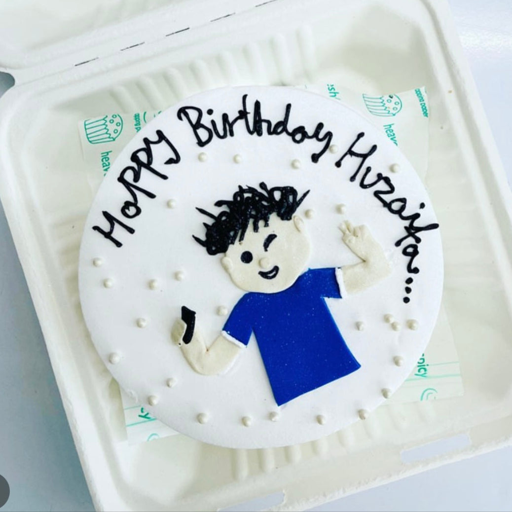 A delightful birthday cake adorned with a playful blue boy decoration, ready to make any celebration memorable.