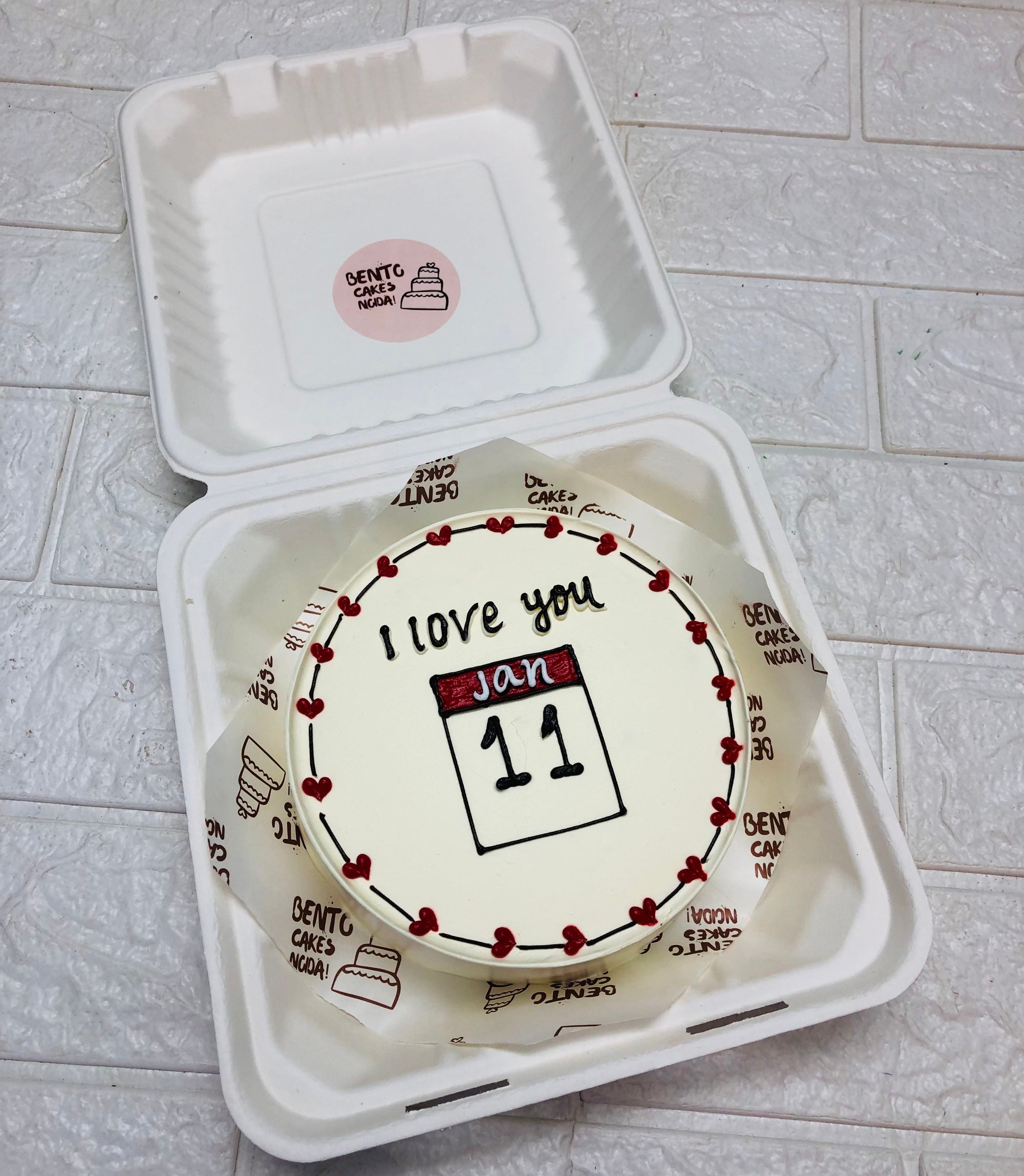 An off white bwnto cake having red calender date theme.