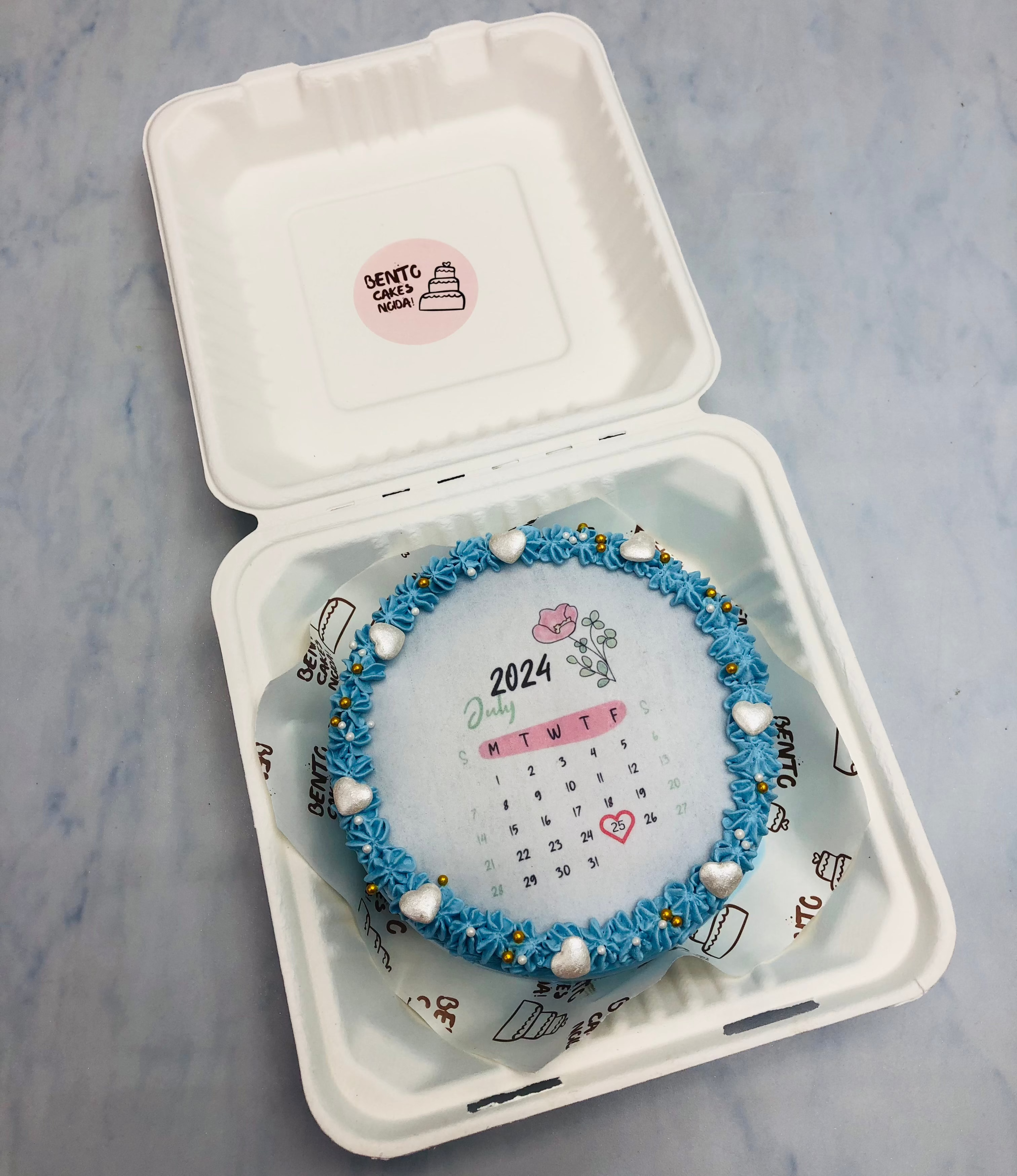 A blue fire bento cake with calendar theme is designed for birthday.