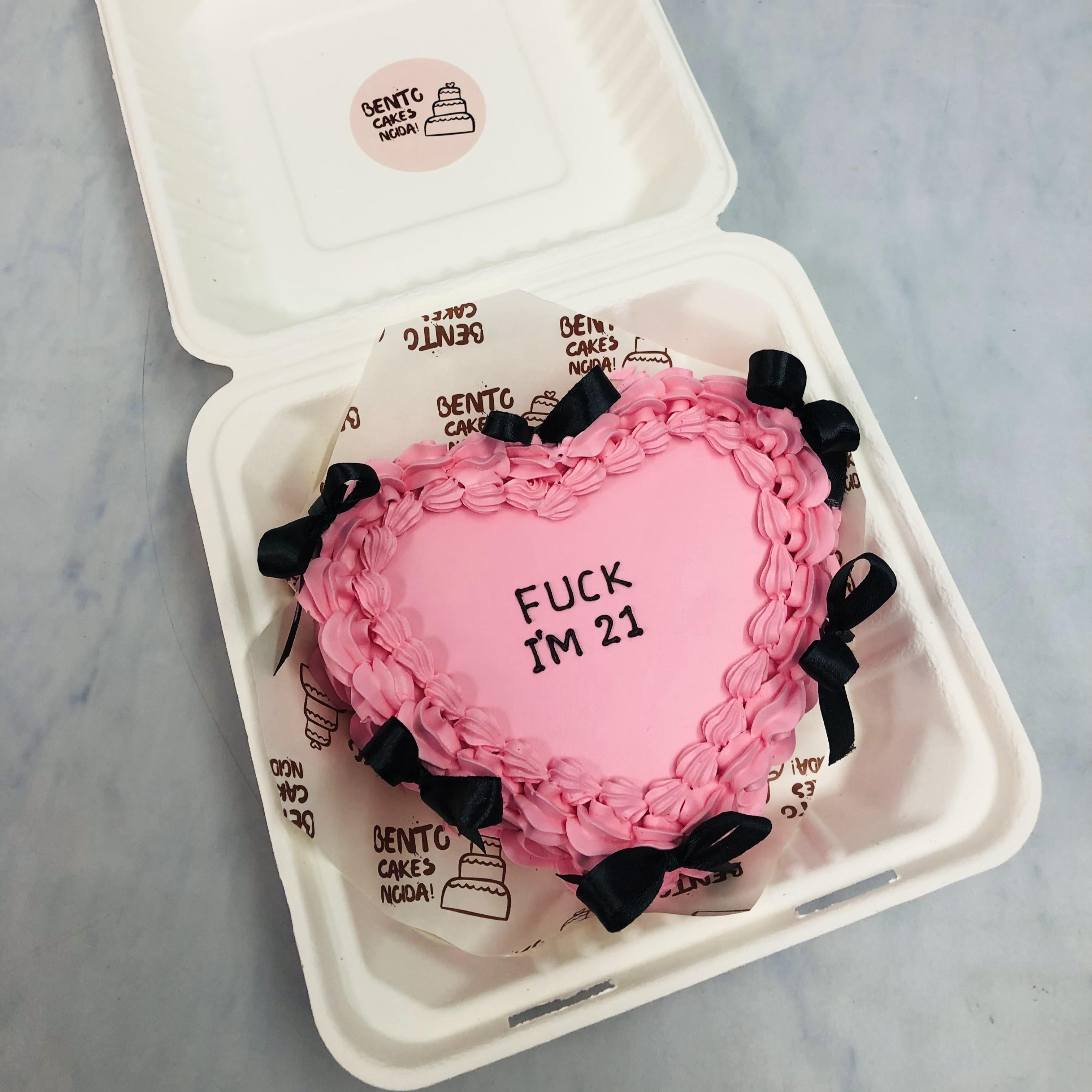 A Black Bow Heart Shape Bento Cake with a black text.
