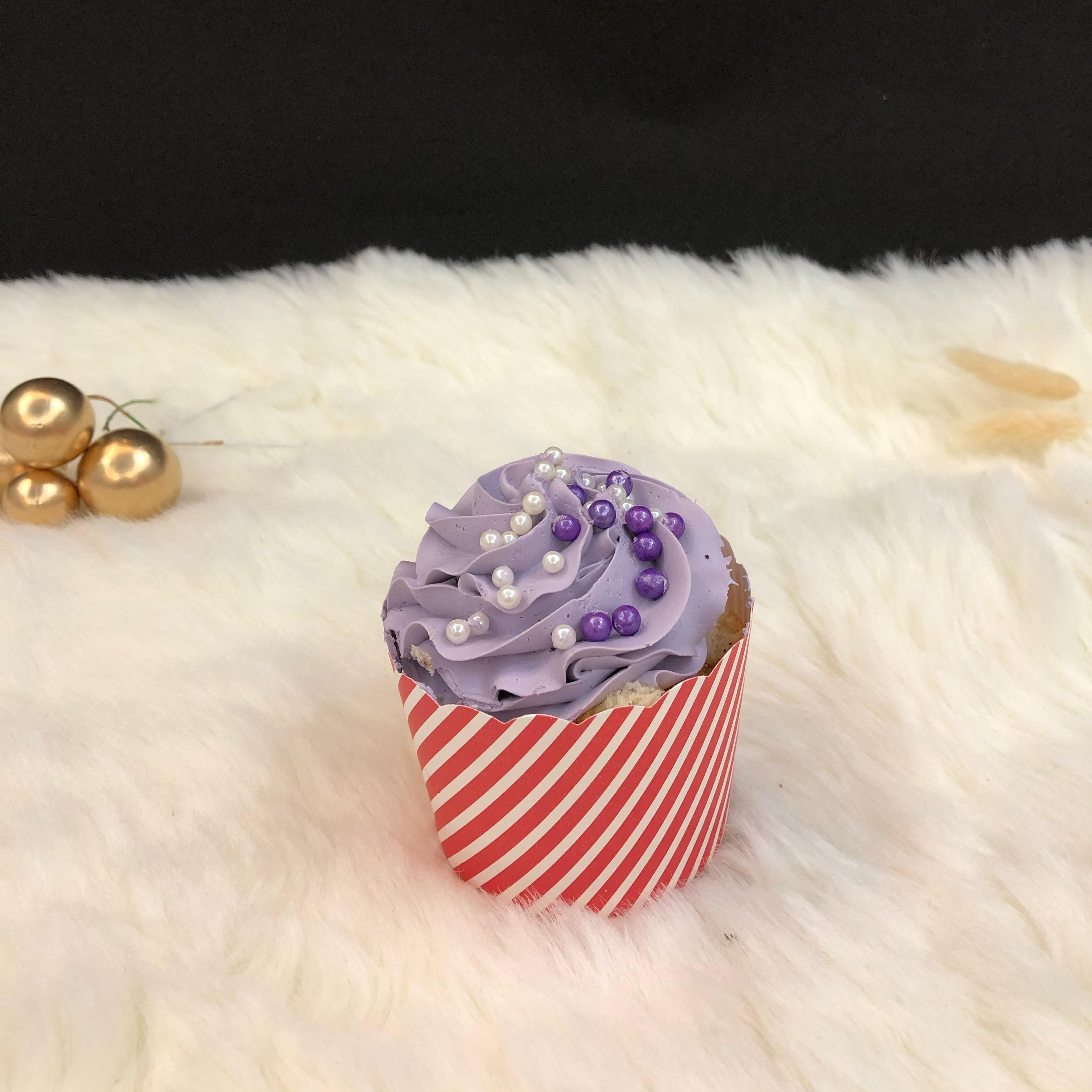 A cupcake filled with Black Current Flavour.