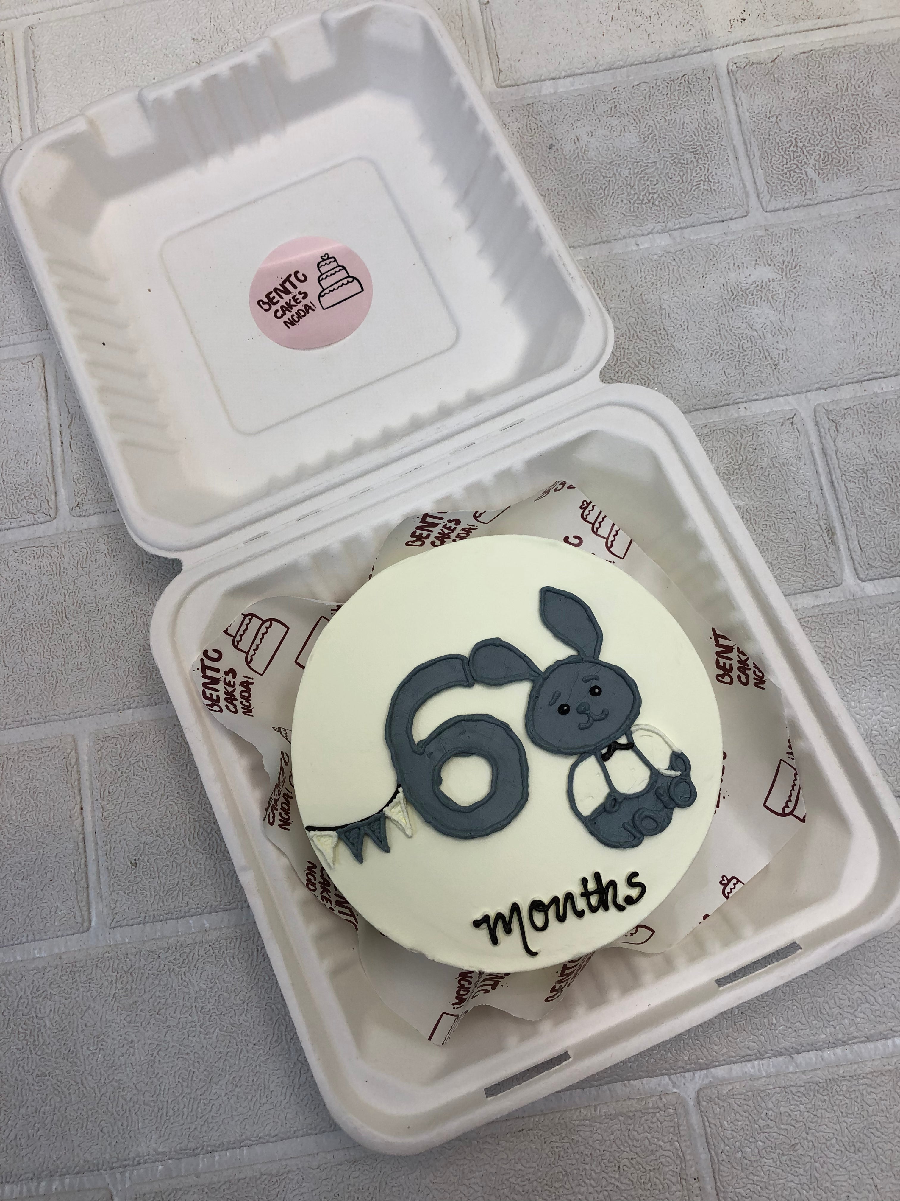 Grey white rabbite deign on a white bento cake for 6 months baby.