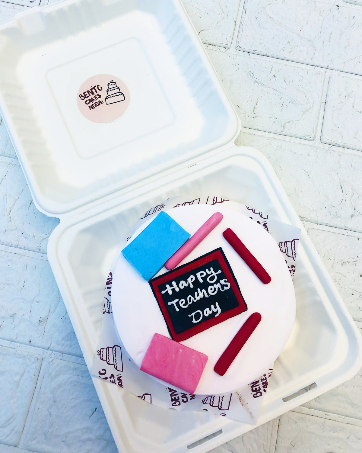 A white bento cake is designed on classroom theme with fondant articles  for Teachers Day.