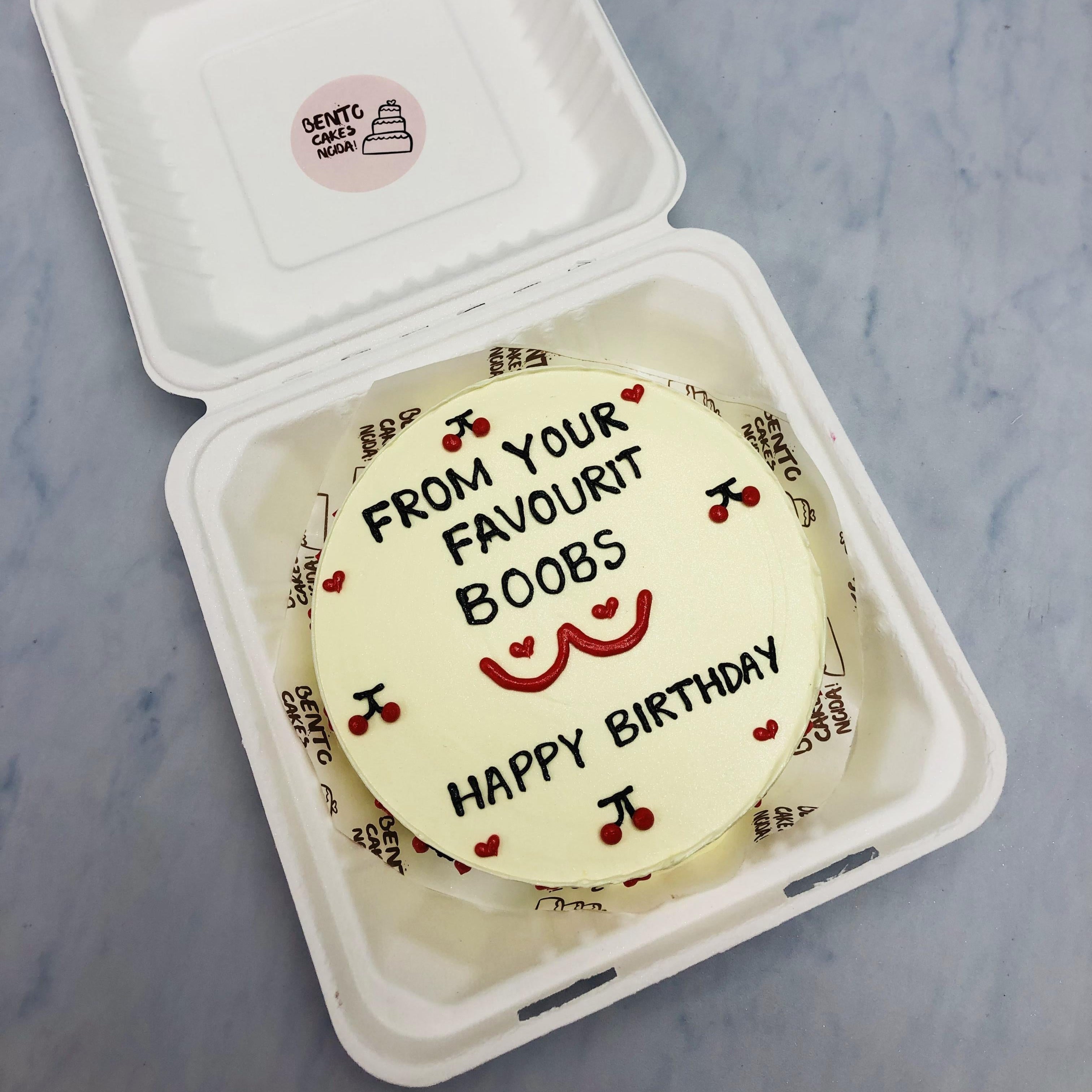 An offwhite bento cake having cherry designs and a bachelor content written on it.