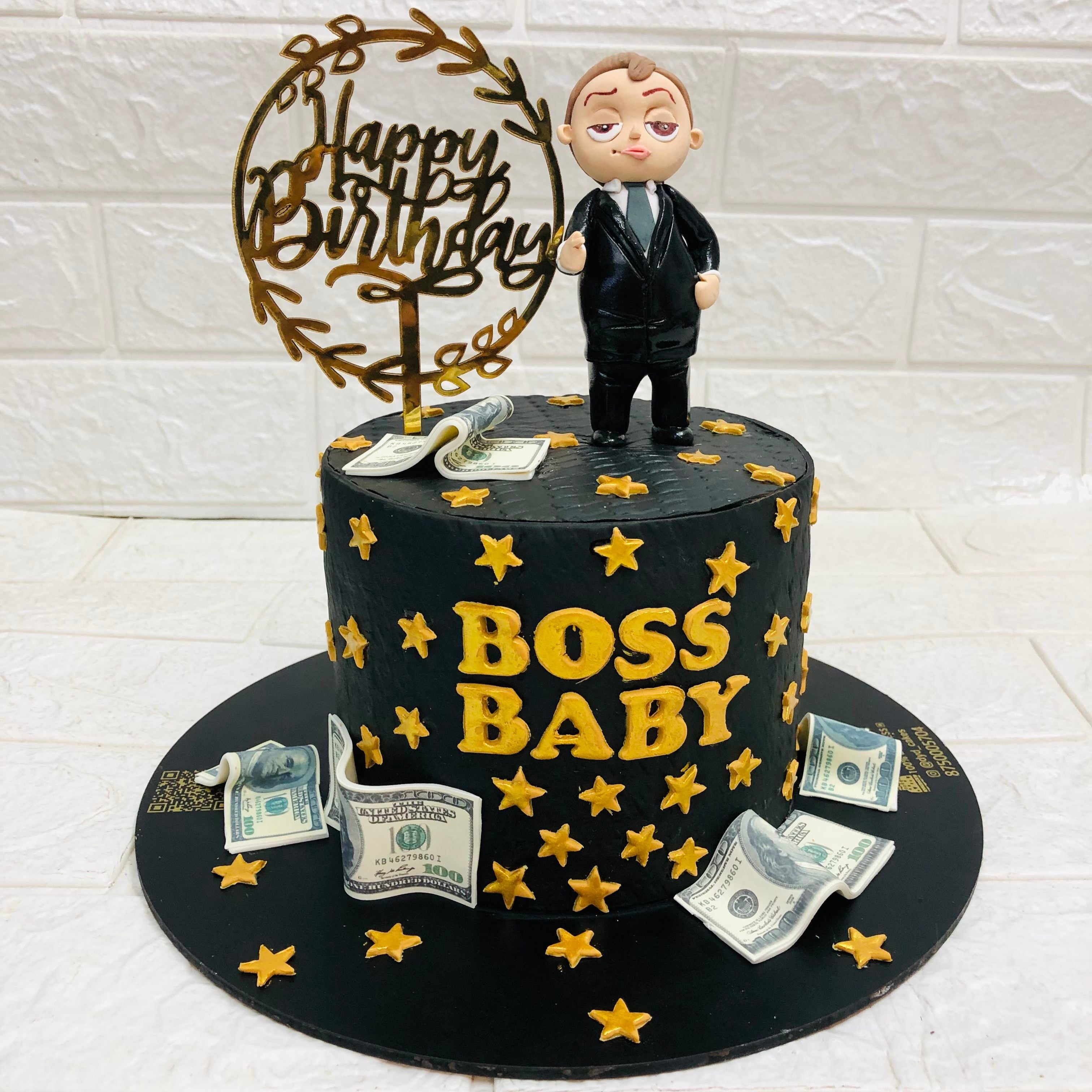  cake adorned with boss baby in a suit and stacks of money on top, symbolizing celebration and wealth.