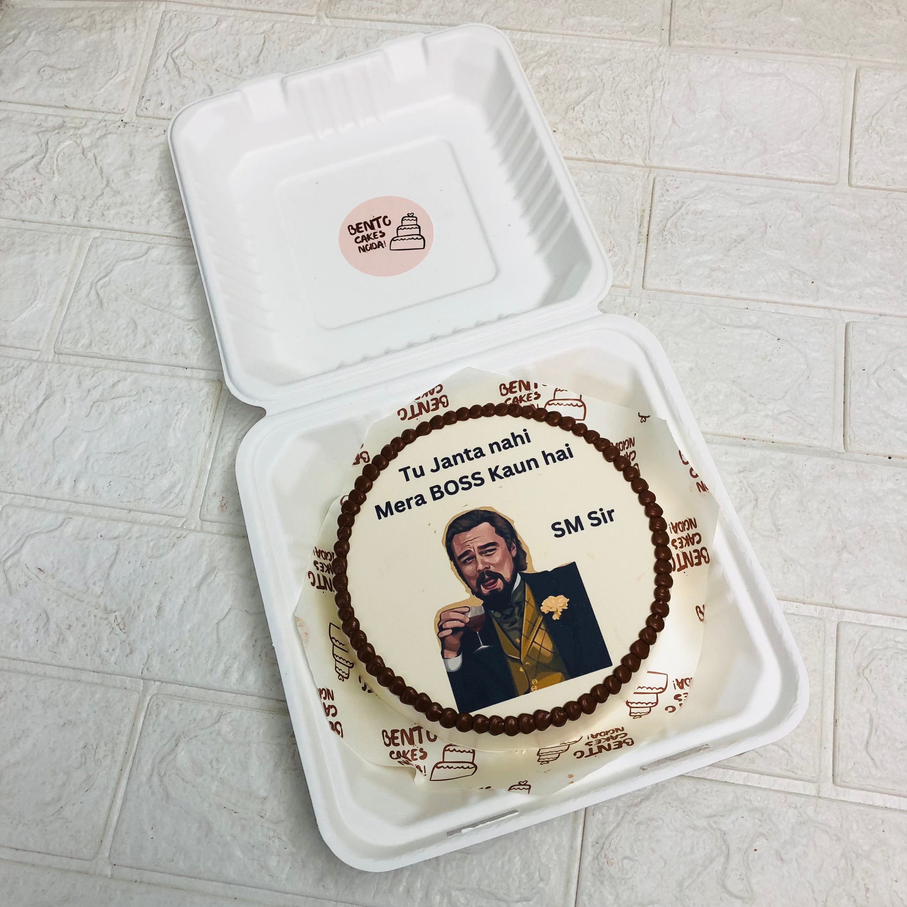 A decorated cake displaying a man's image, perfect for celebrating a birthday or special event.