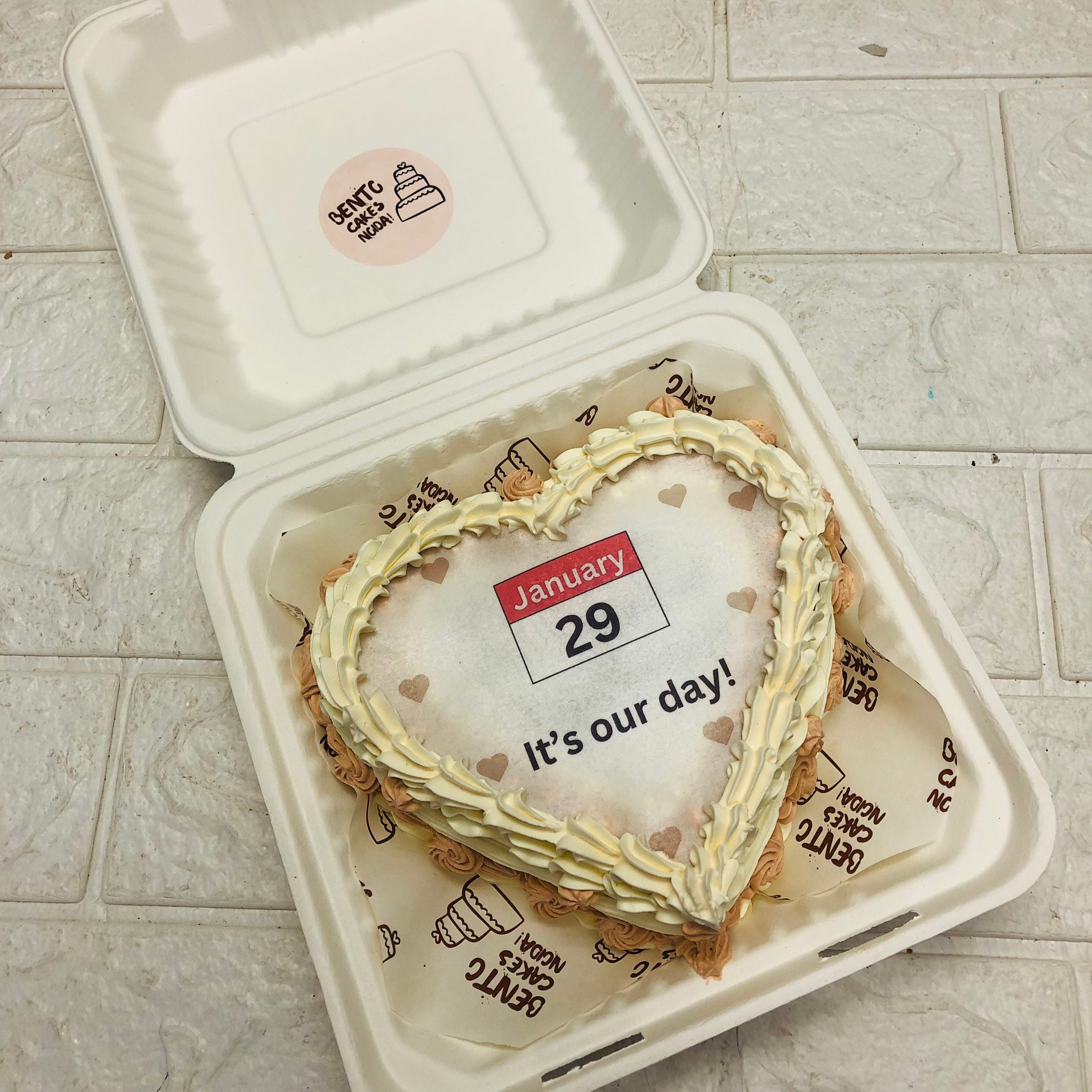 A delightful heart-shaped fire cake in a bento box, elegantly designed with colorful icing, symbolizing love and perfect for anniversary celebration.