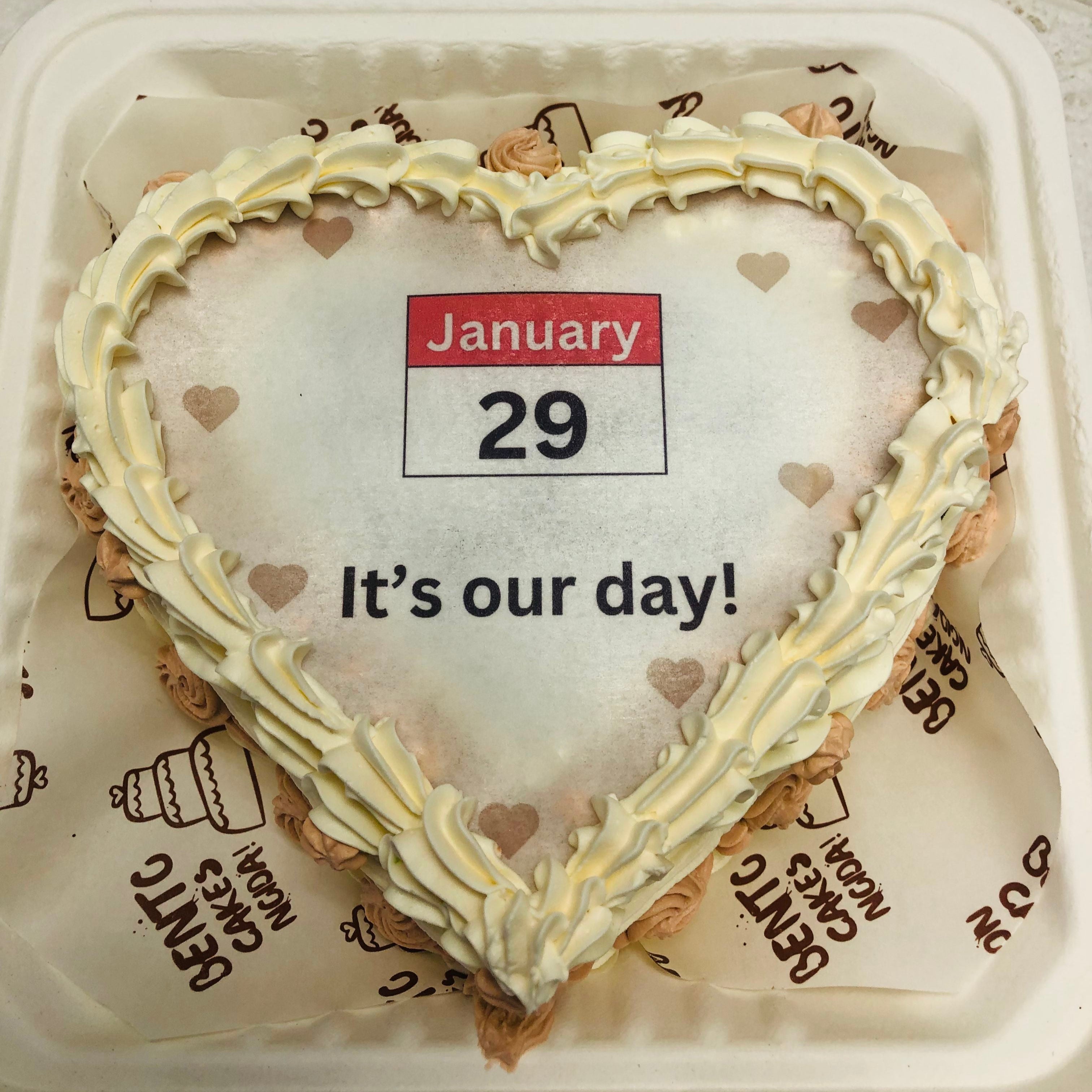 A delightful heart-shaped fire cake in a bento box, elegantly designed with colorful icing, symbolizing love and perfect for anniversary celebration and visible from top view.