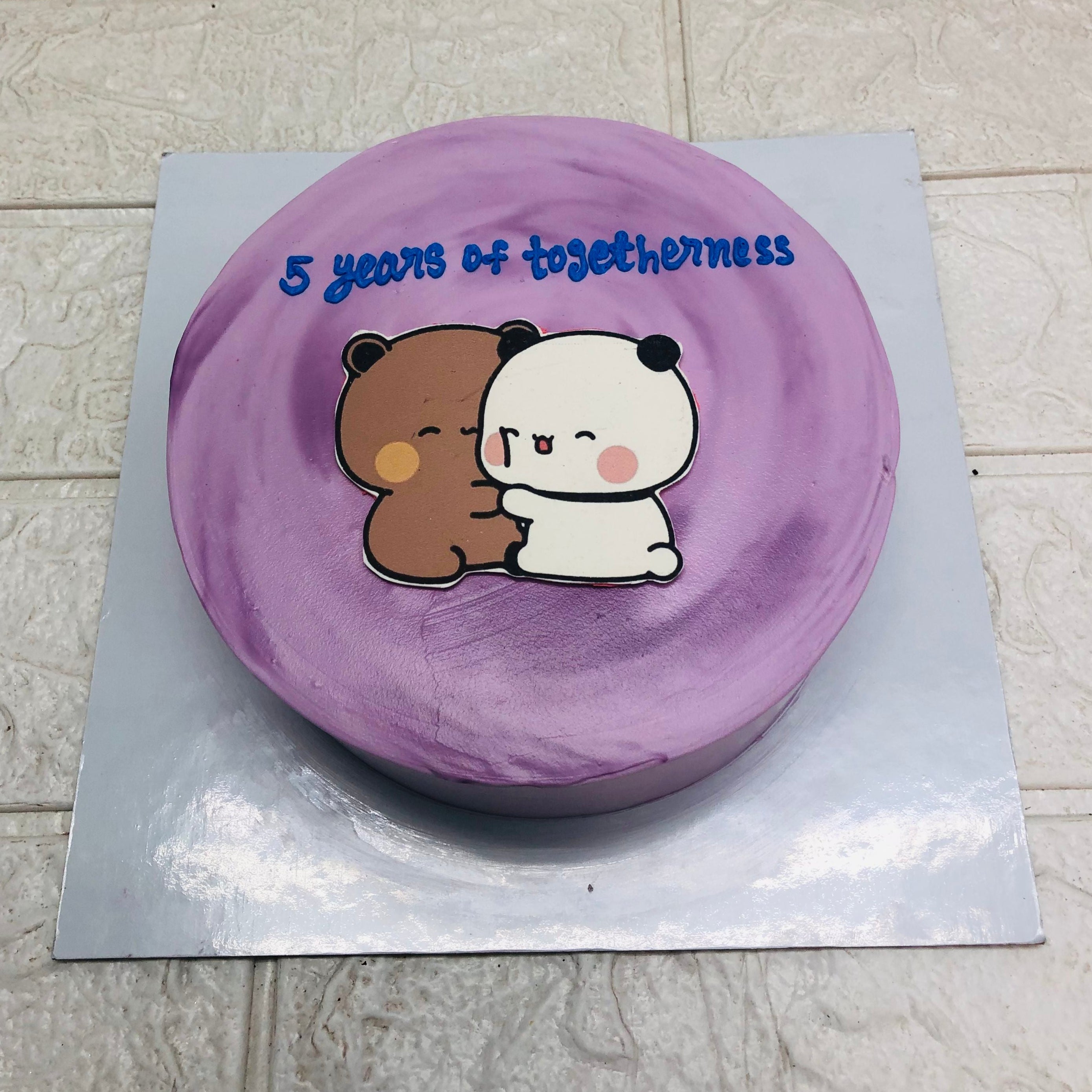 A delightful cake adorned with a bubu dudu cartoon figure, ideal for a festive occasion or celebration.