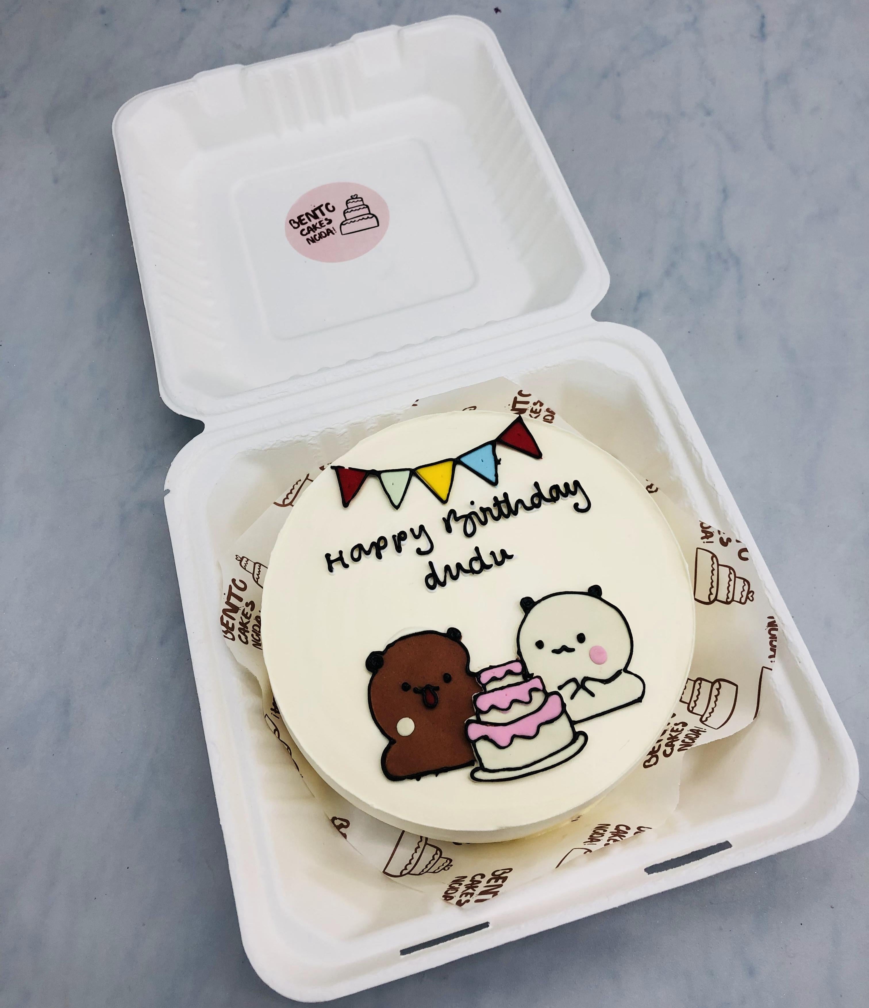 An offwhite bento cake having a bubu dudu drawing, celebrating dudu's birthday.