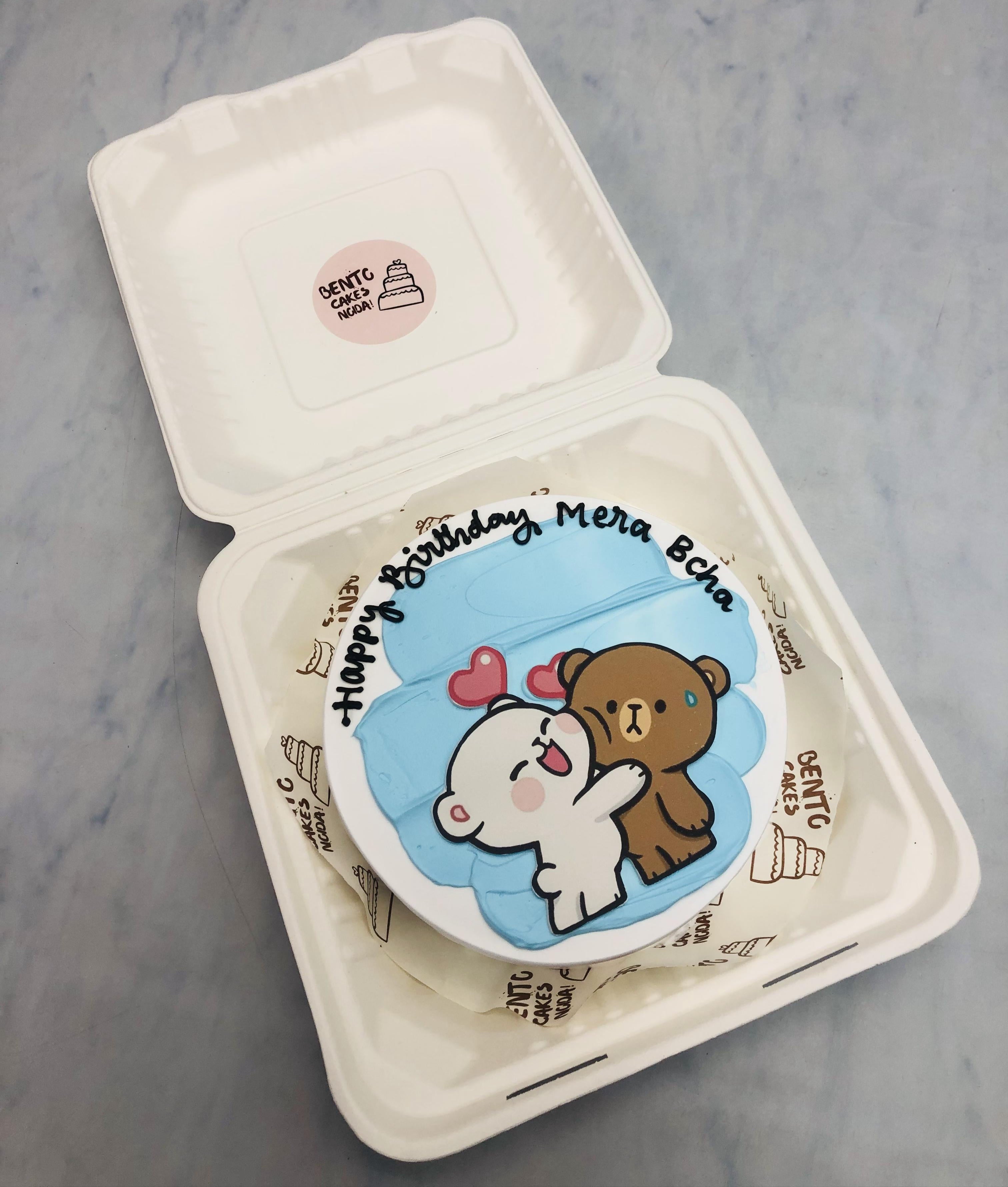 Light blue shades on a white bento cake having lovely bubu dudu.