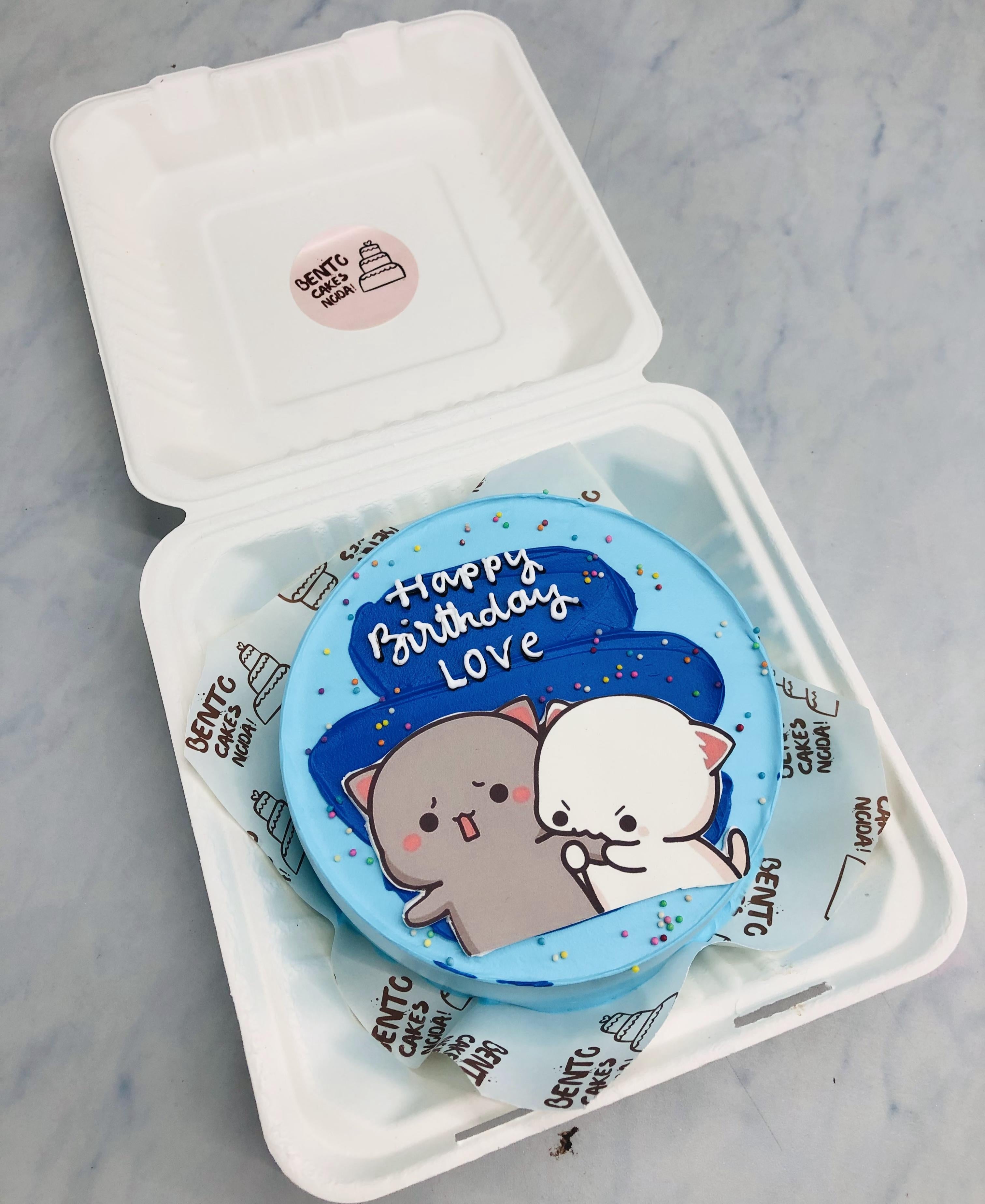 An aesthetic blue shades bento cake with biting dudu print.