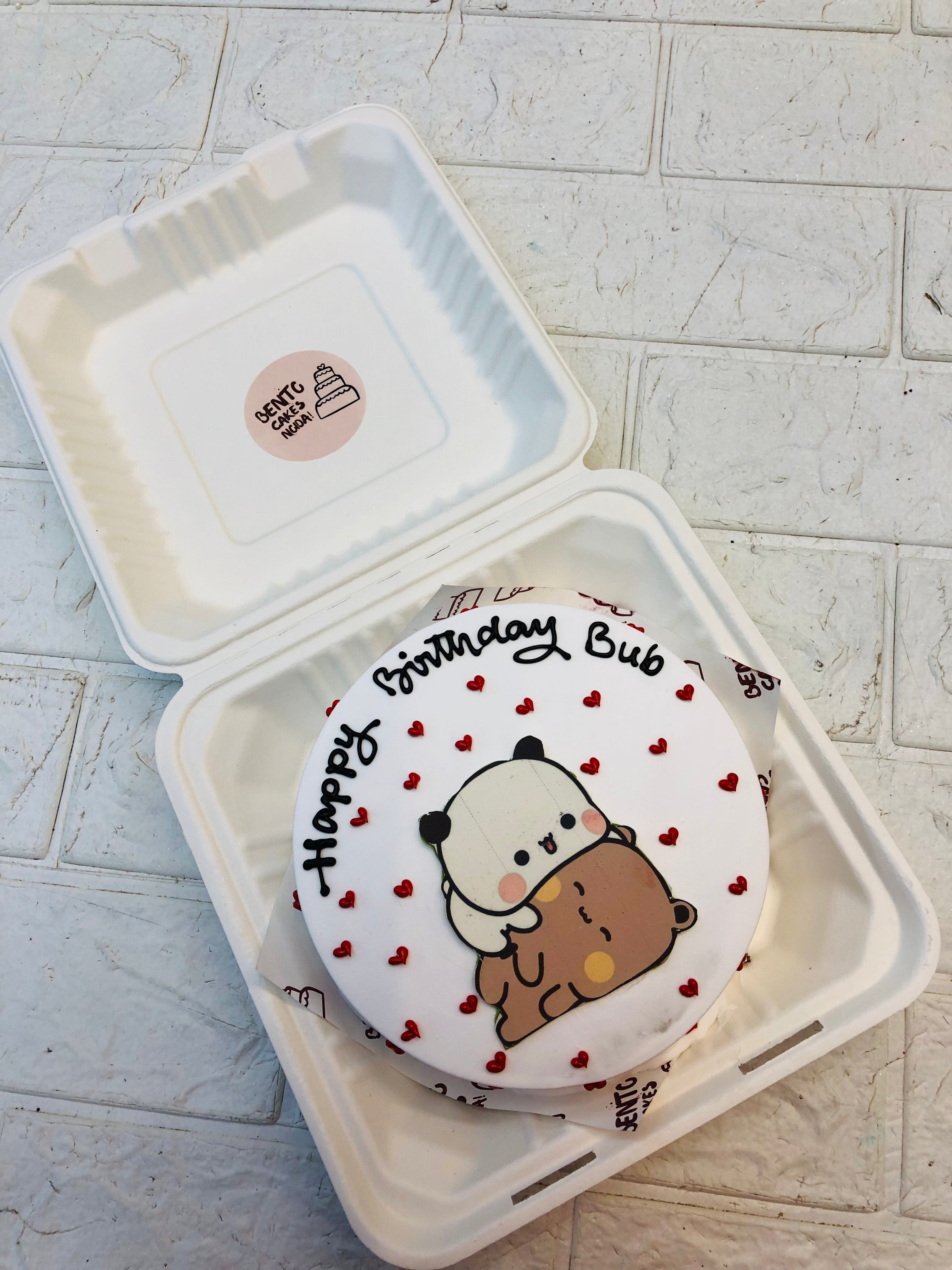 A white bento cake with slpeepy dudu and decorated with red hearts.