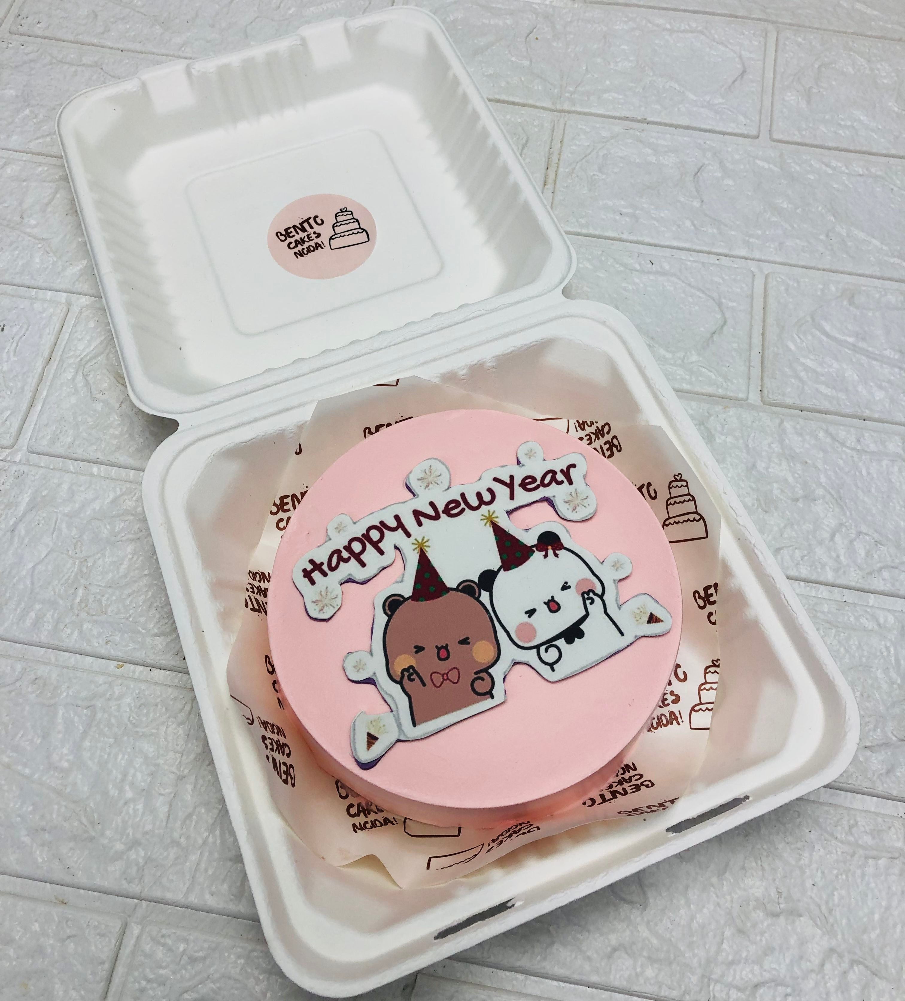 A light pink bento cake having happy bubu dudu print celebrating New Year.