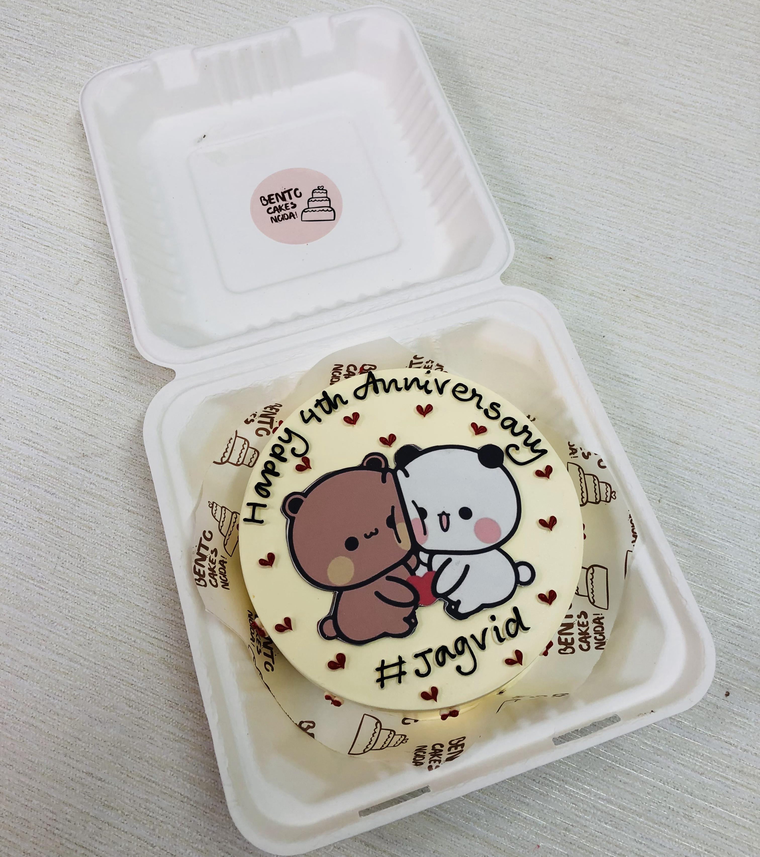 An off white bento cake with attached bubu dudu, designed for anniversary.