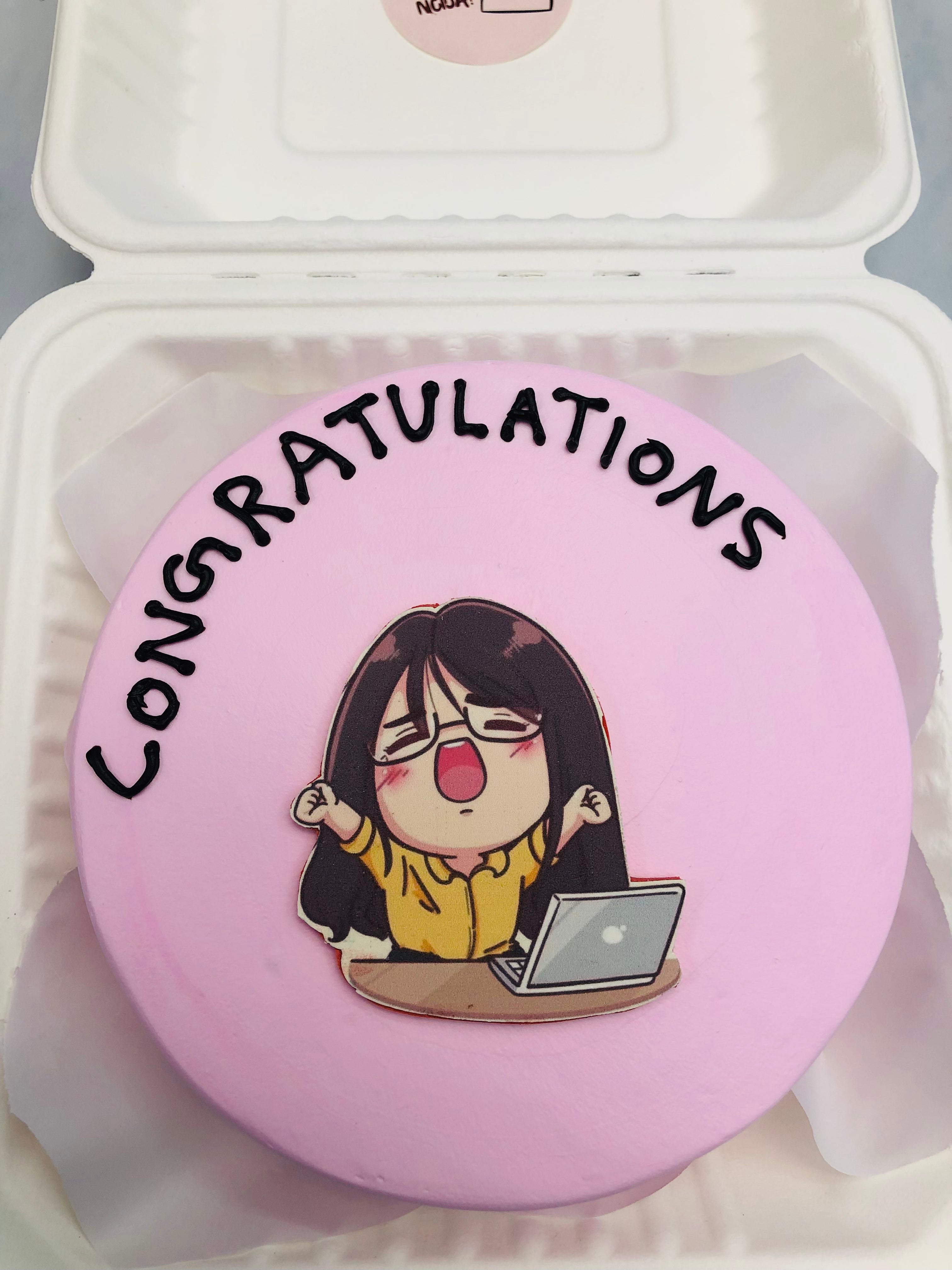 A light pink bento cake for a woraholic girl with laptop celebrating her success.