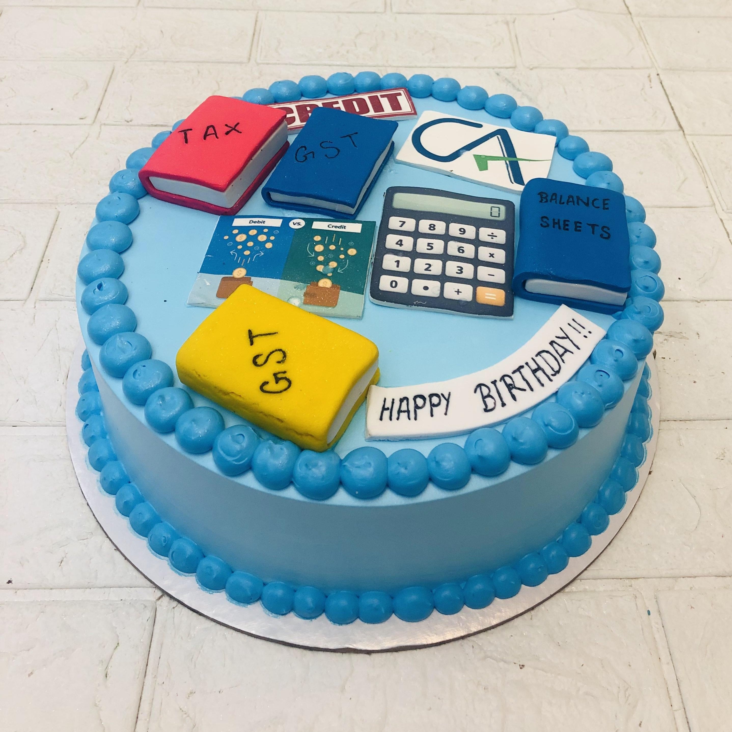 A birthday cake surrounded by a calculator and various festive items, symbolizing a celebration of knowledge and fun.
