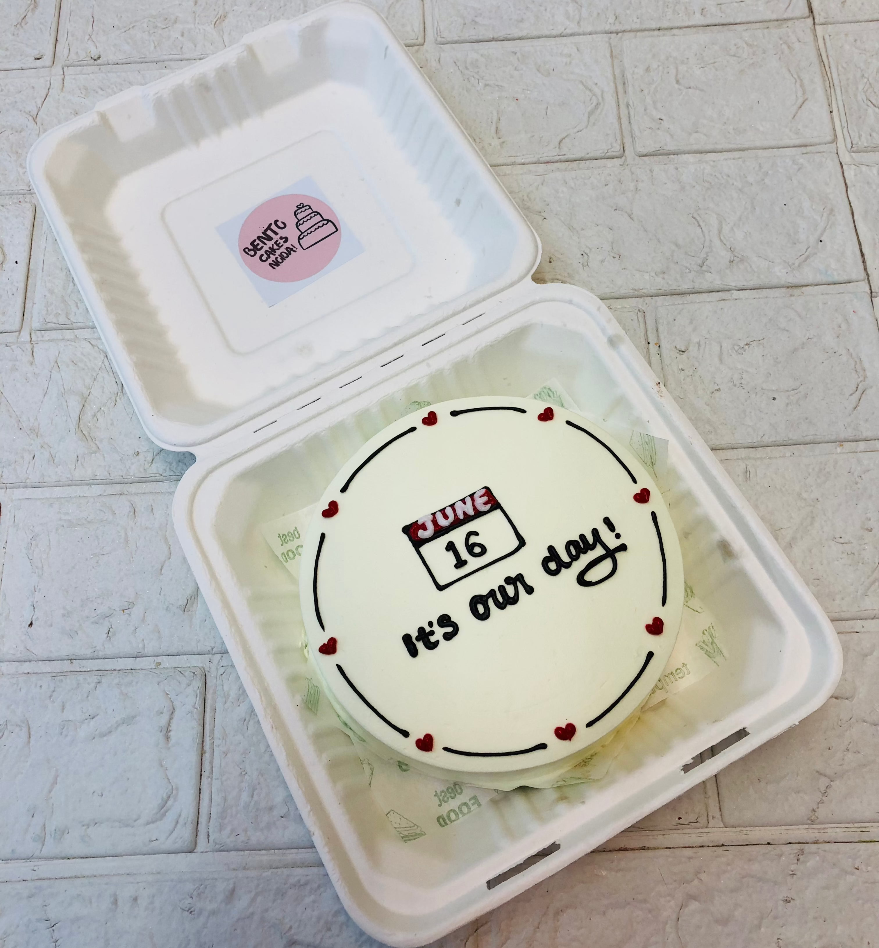 A white bento cake with july calendar date for anniversary occasion.