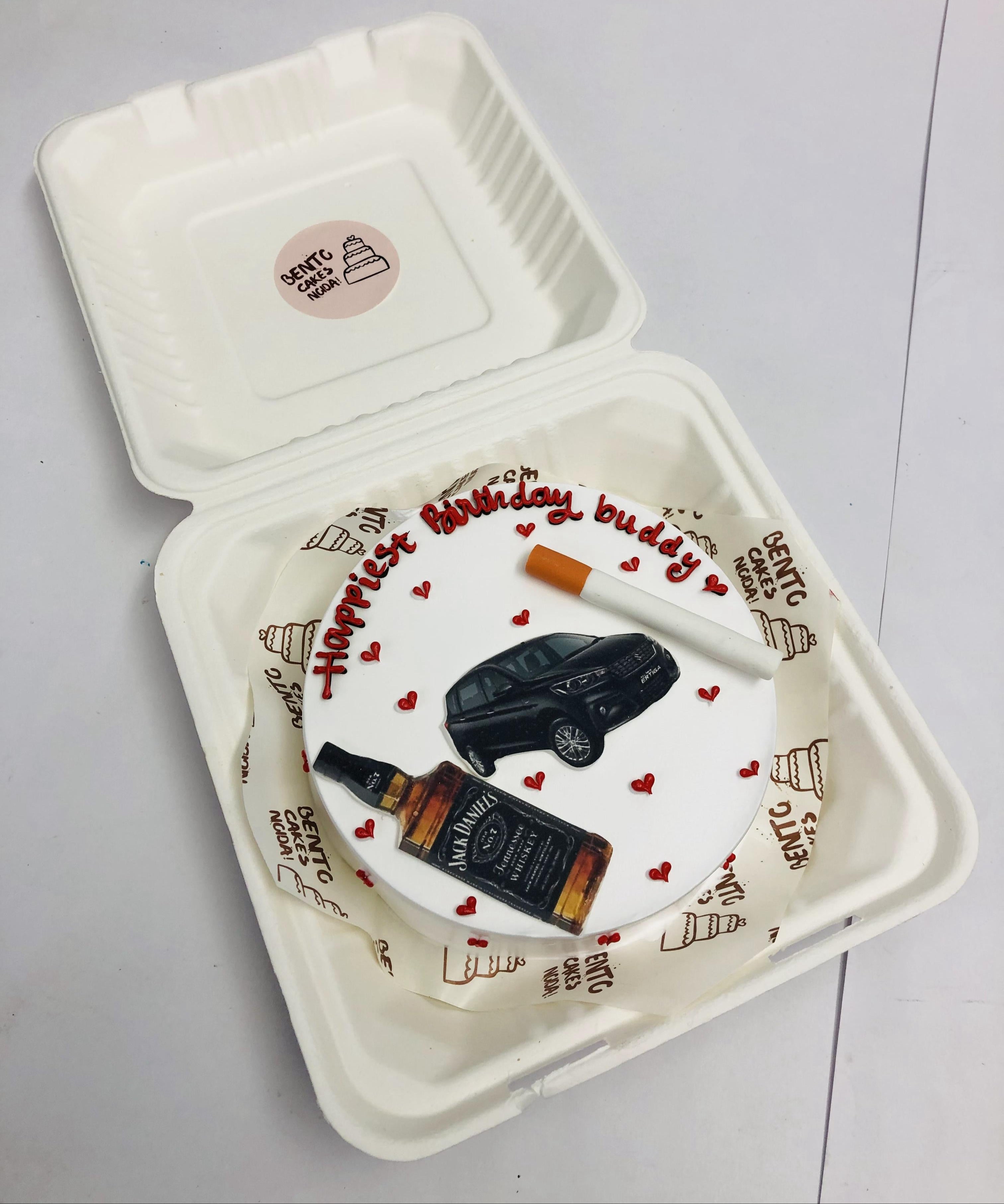 A white bento cake is designed for luxorious men's birthday with bear bottle, car print with fondant cegrette desgn.