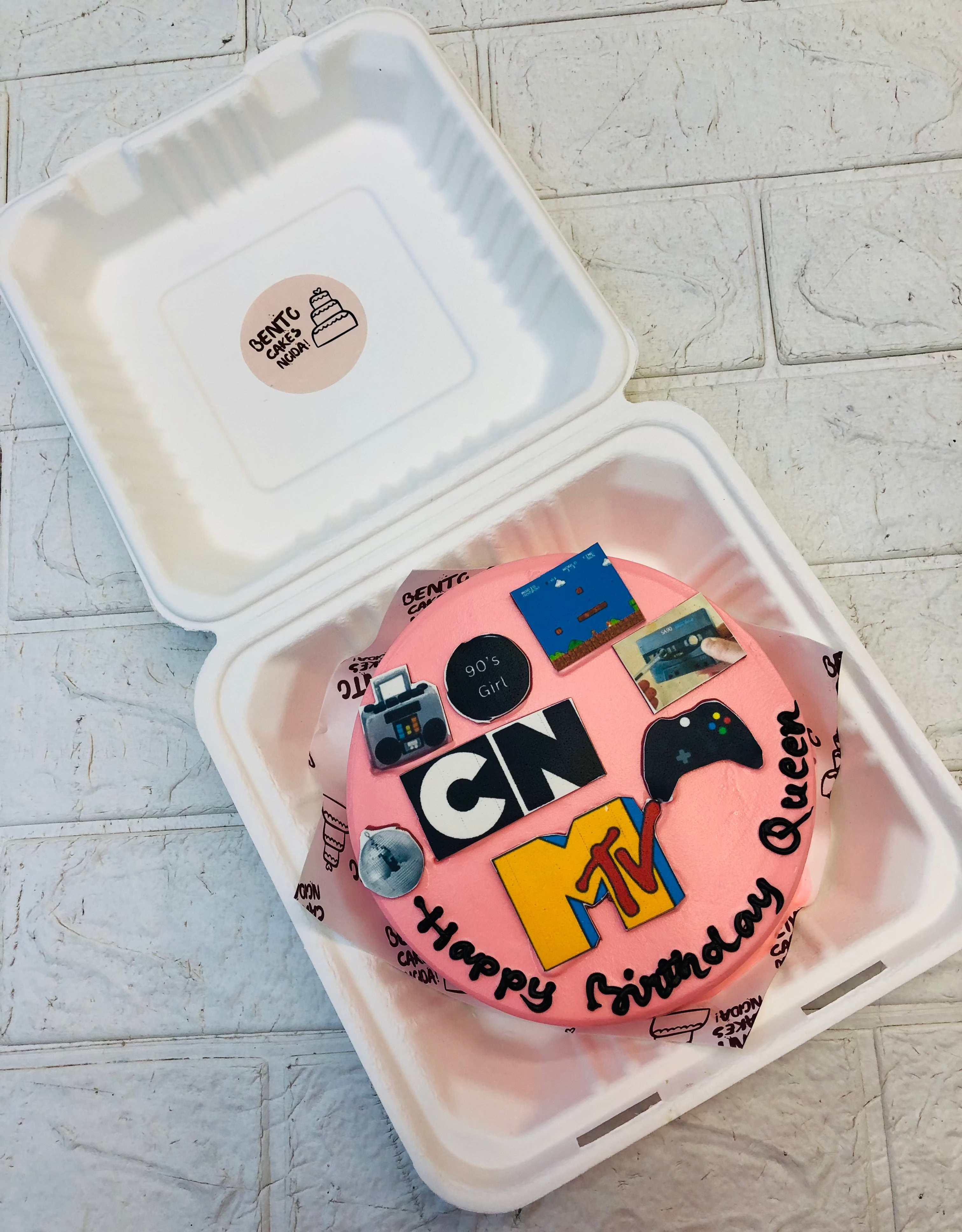 A rose pink bento cake designed with cartoon network, gaming, sports lovers girls birthday.
