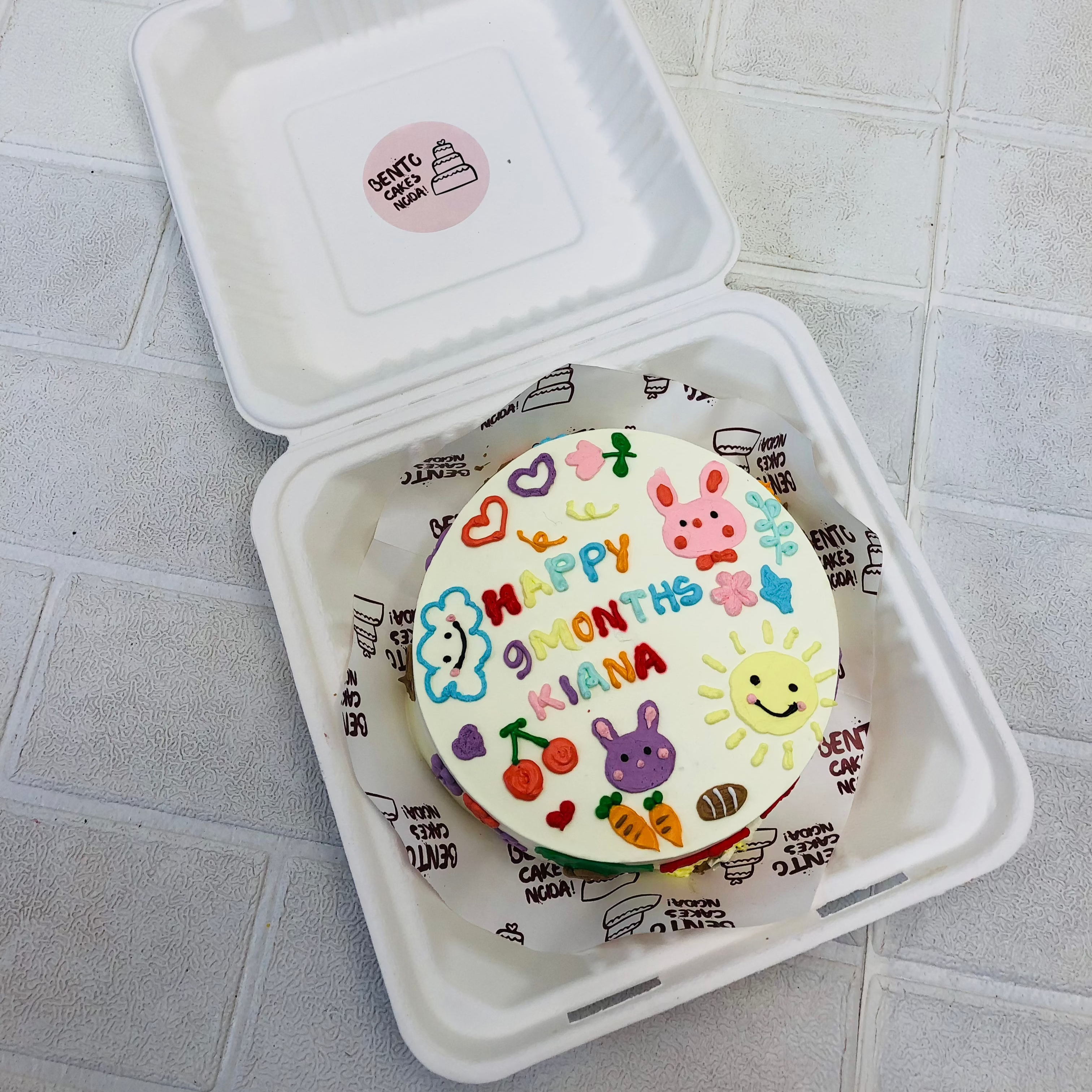 A white bento cake for 9 months baby designed with cute charaters.