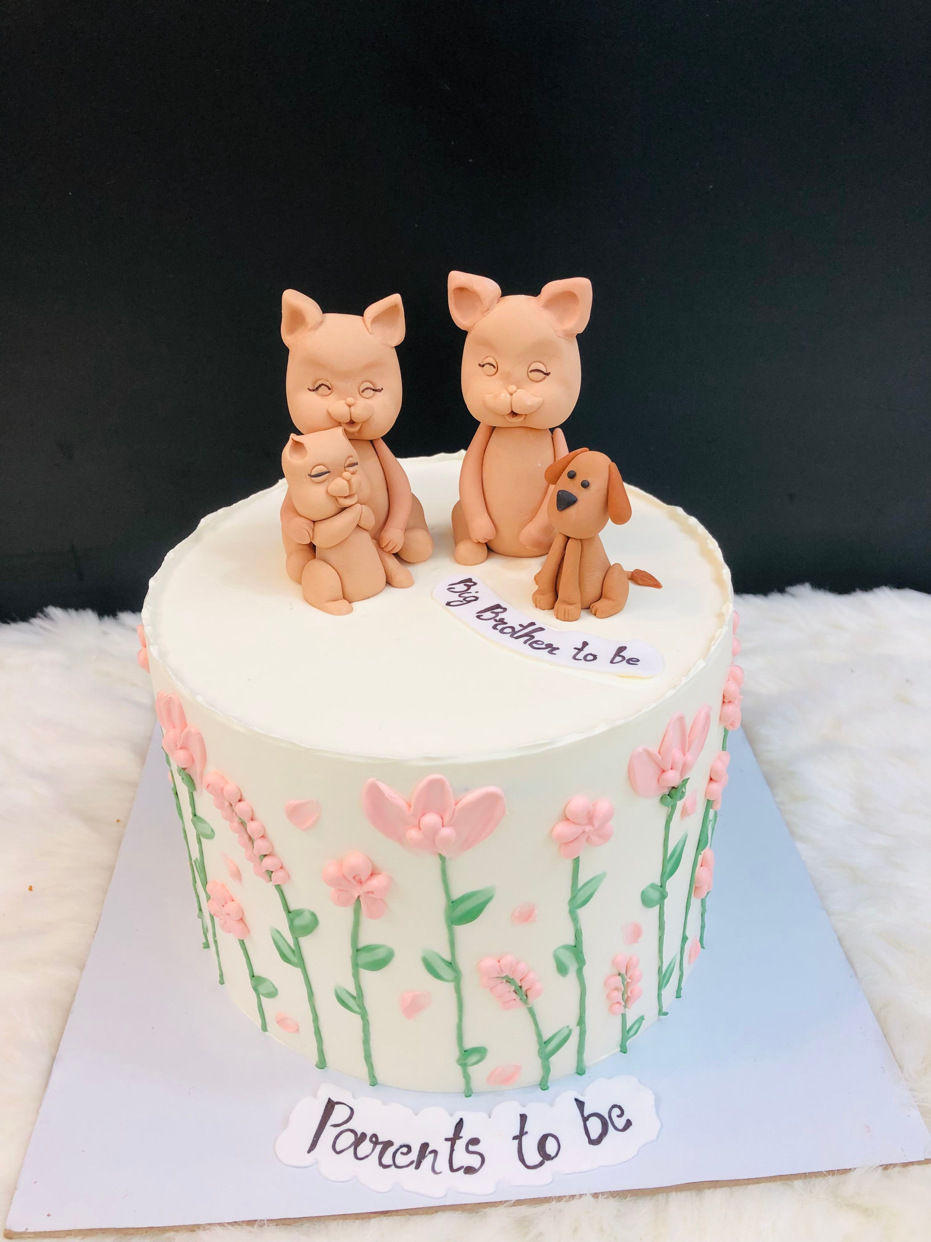 A delightful cake showcasing three cats and a dog sitting on it, creating a whimsical and fun centerpiece.