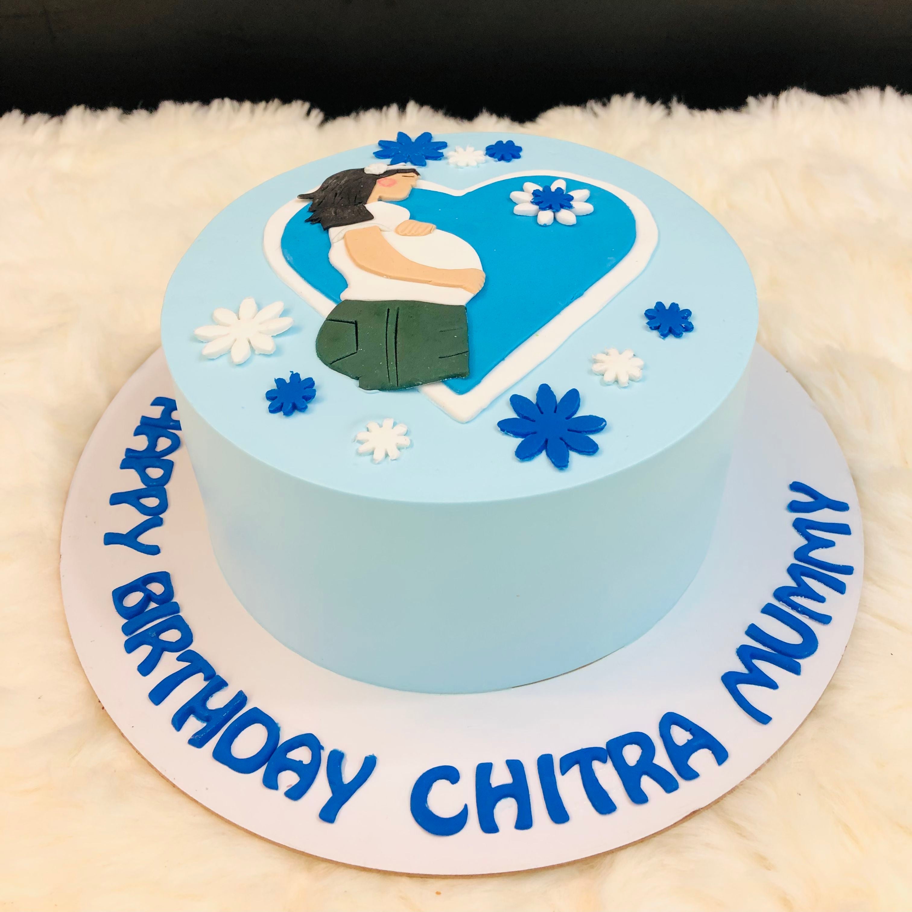 A blue and white cake featuring a charming design, perfect for a delightful baby shower celebration.