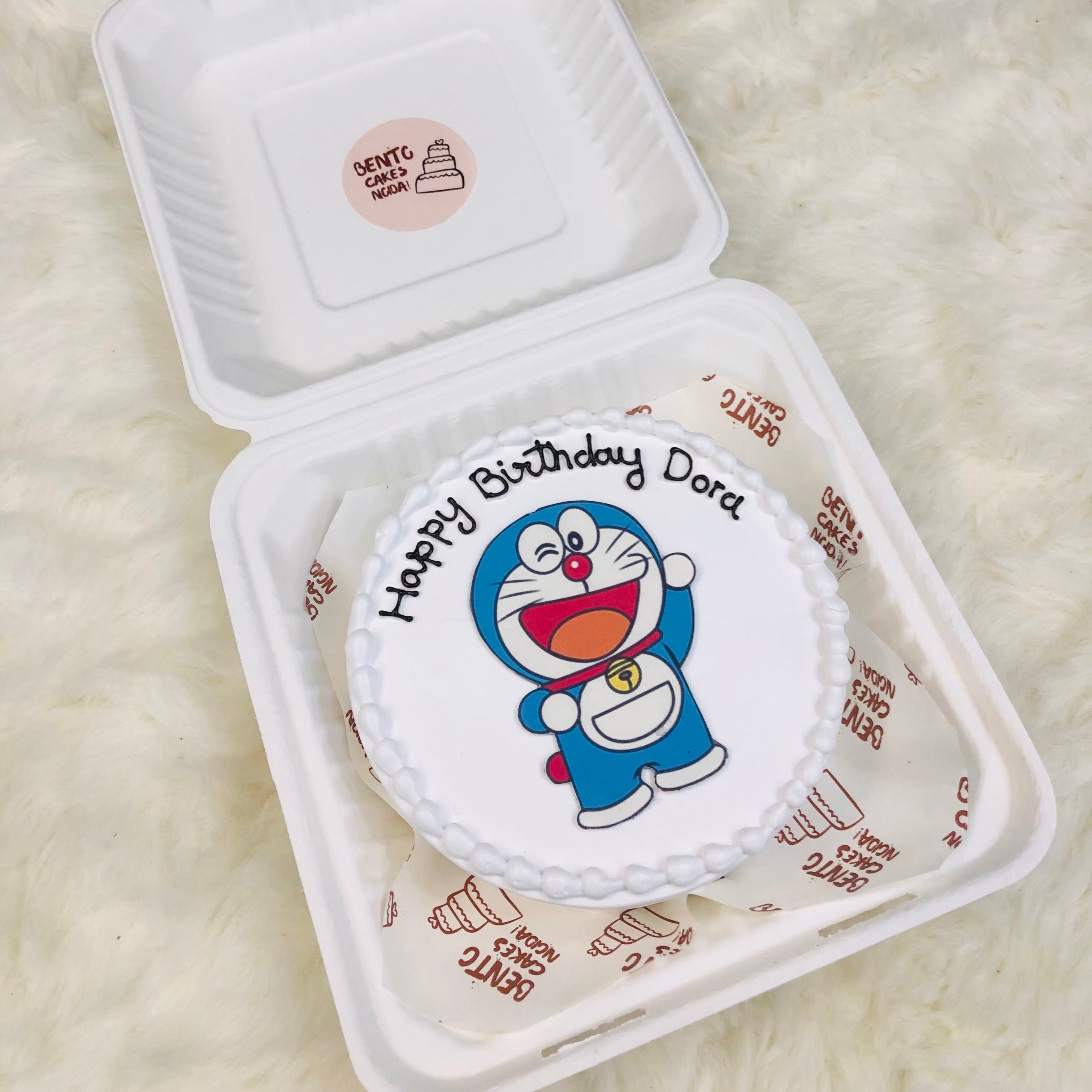A colorful cake topped with a cheerful Doremon cartoon, perfect for a fun celebration or birthday party.