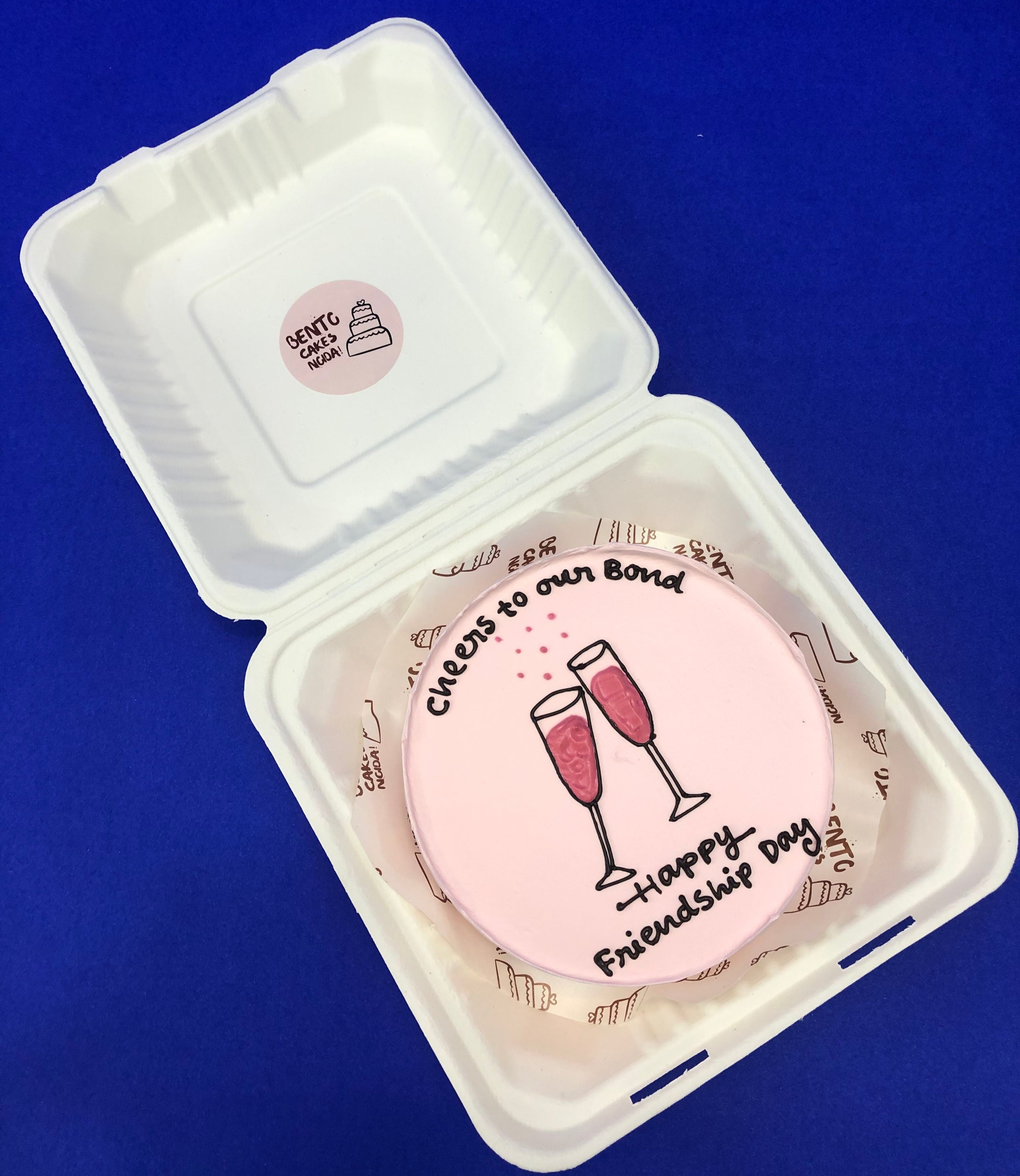 A rose pink bento cake having cheers glass for riendship day celebration.