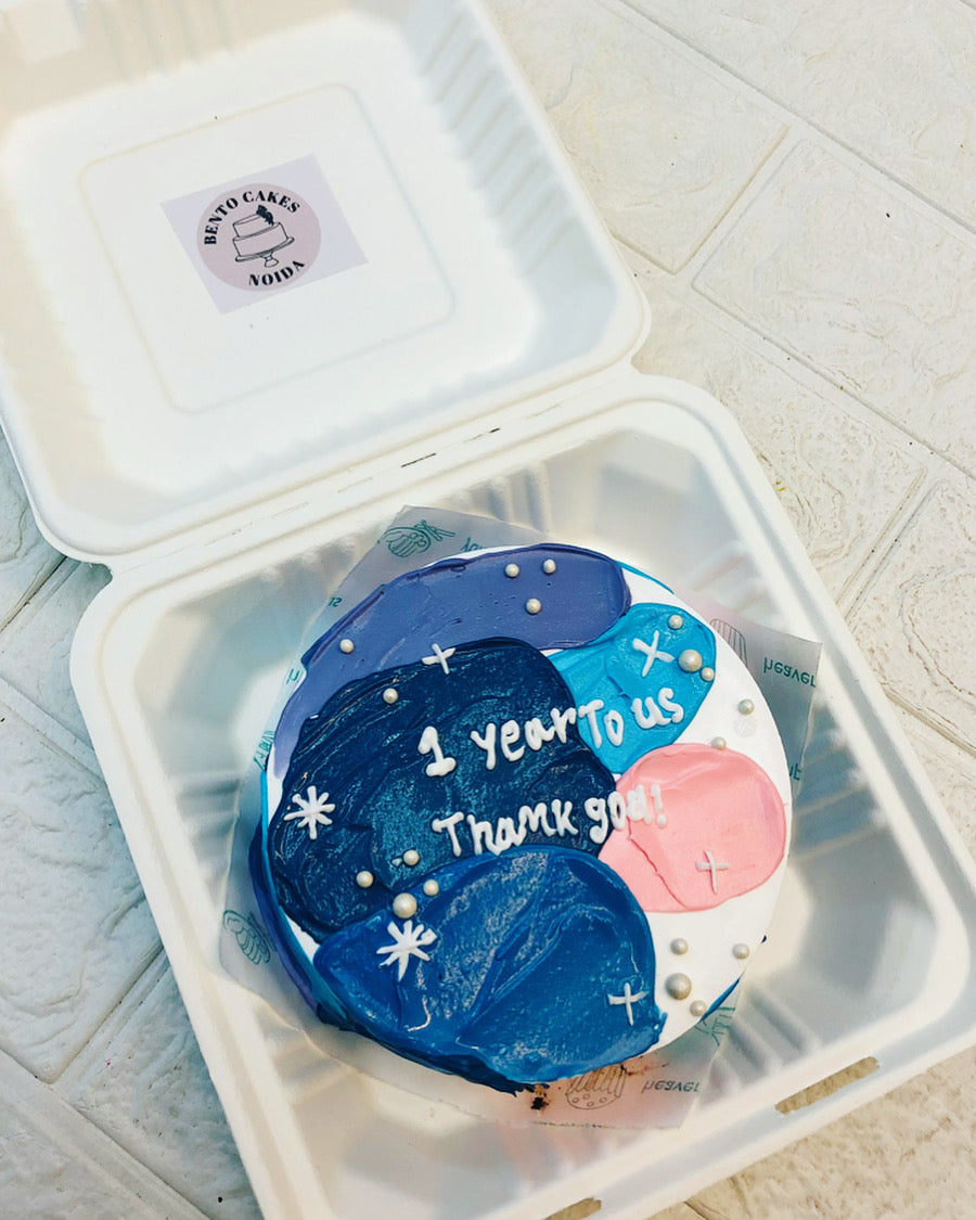 A beautifully decorated cake nestled inside a bento box, ready for presentation or delivery.