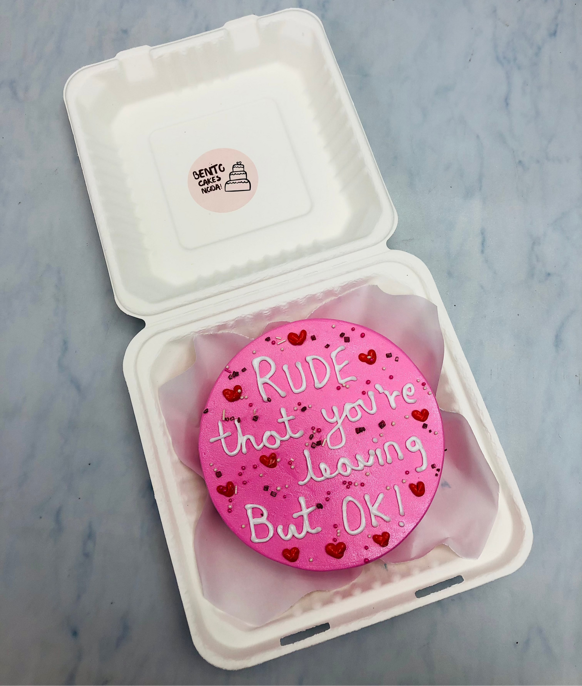 A customized pink bento cake for farewell theme with a loving text written on it.