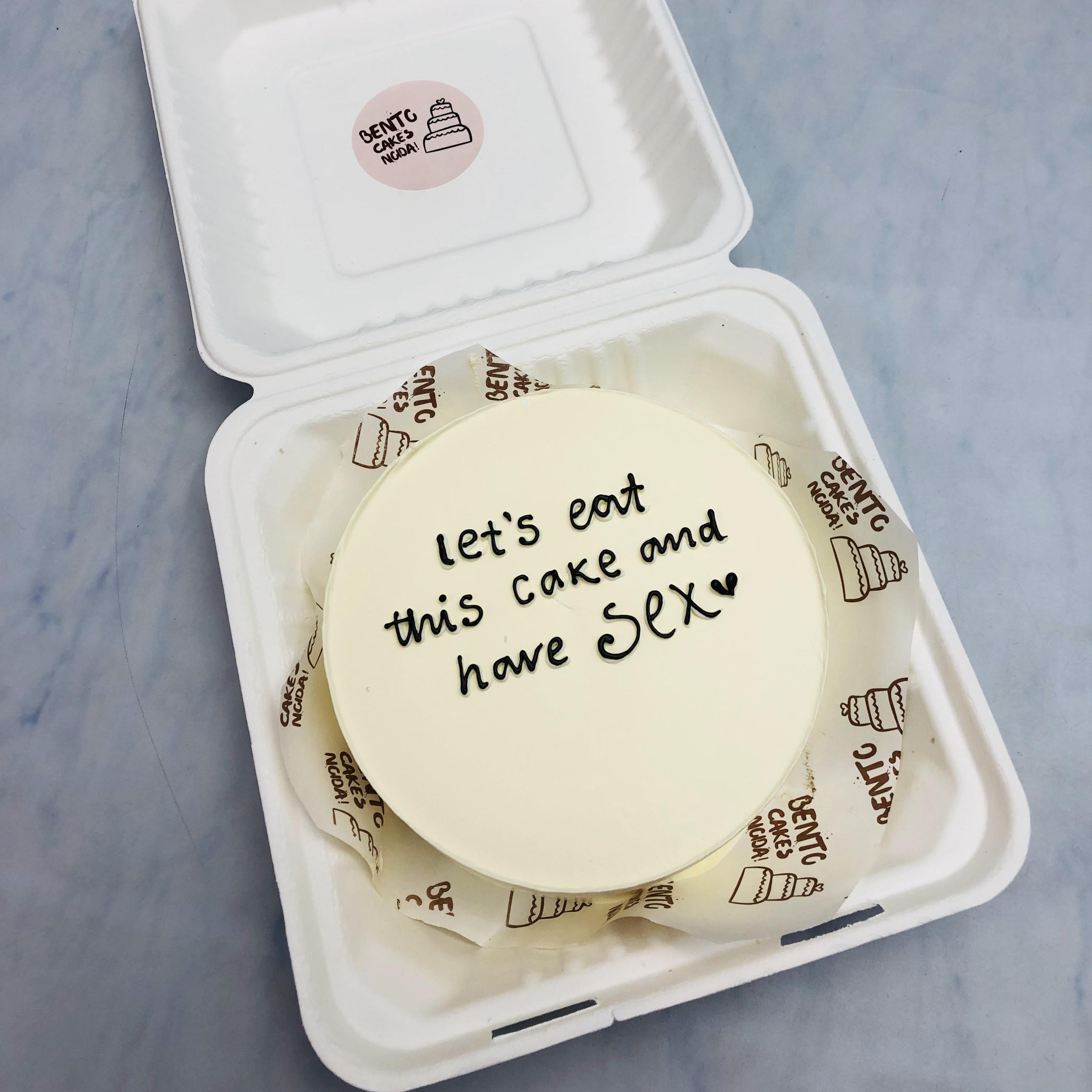 A white bento cake with some bachelor text written on it.